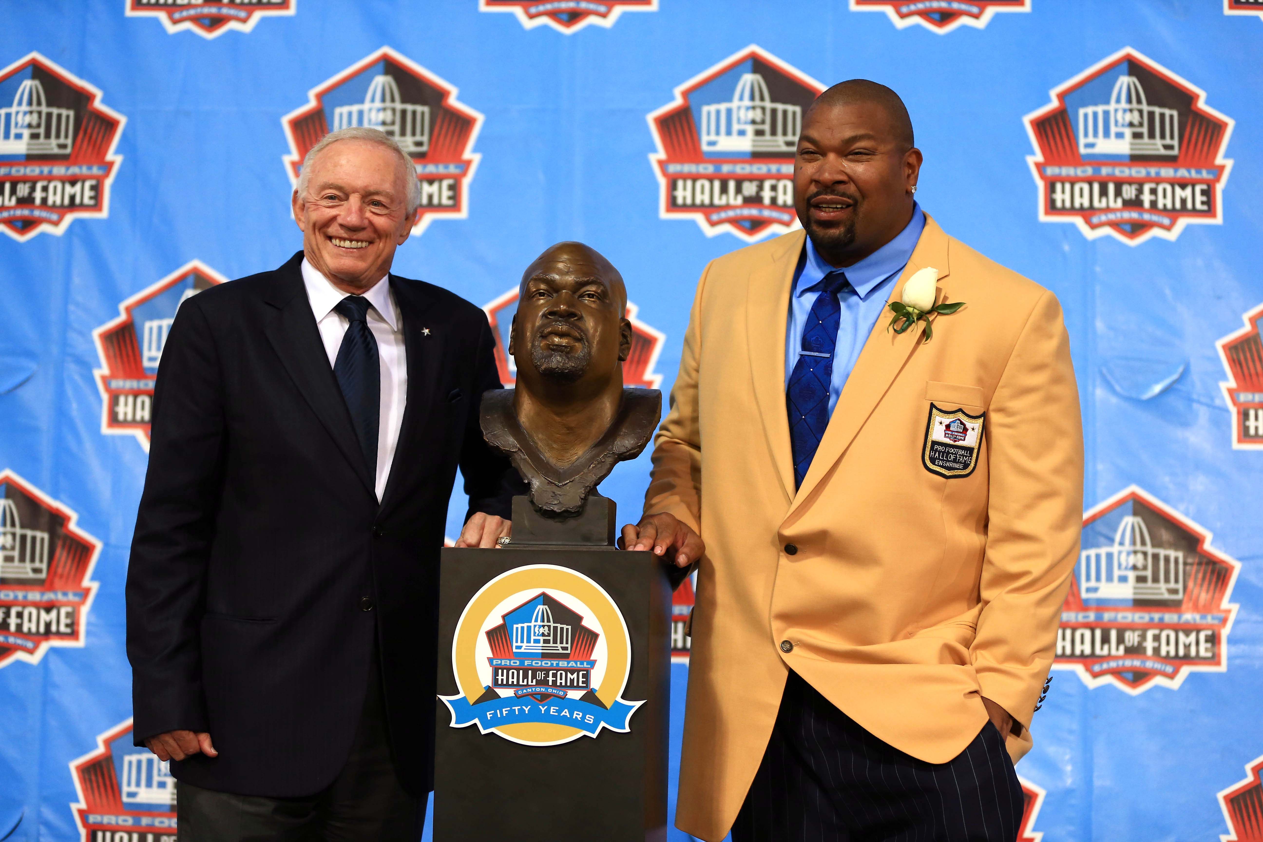 Aug 2, 2013; Canton, OH, USA; Dallas Cowboys former guard Larry Allen and Dallas Cowboys owner Jerry Jones unveil Allen's bust during the 2013 Pro Football Hall of Fame Enshrinement at Fawcett Stadium.