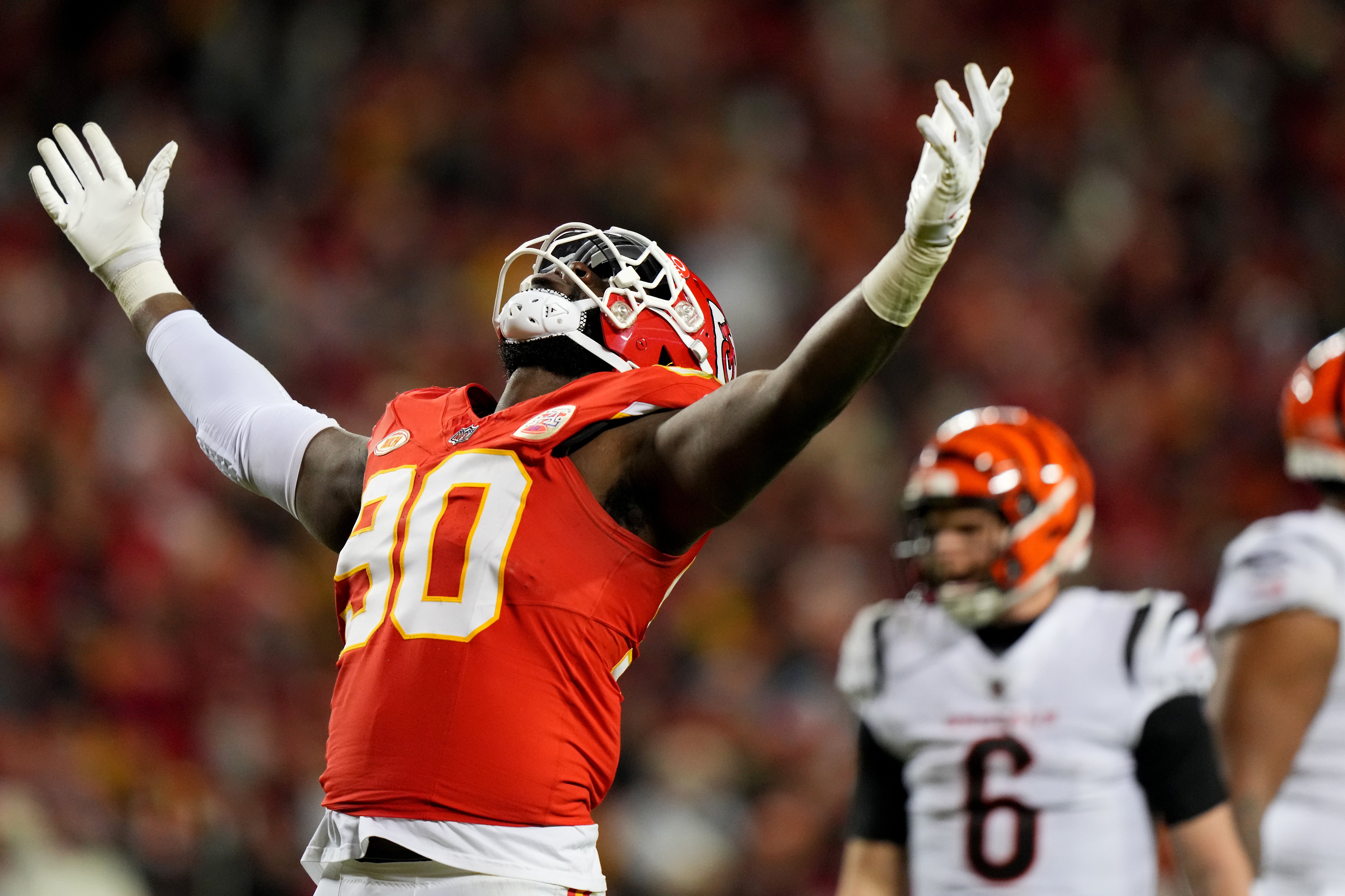 Dec 31, 2023; Kansas City, Missouri, USA; Kansas City Chiefs defensive end Charles Omenihu (90) celebrates a sack of Cincinnati Bengals quarterback Jake Browning (6), background, in the fourth quarter during a Week 17 NFL football game between the Cincinnati Bengals and the Kansas City Chiefs at GEHA Field at Arrowhead Stadium.