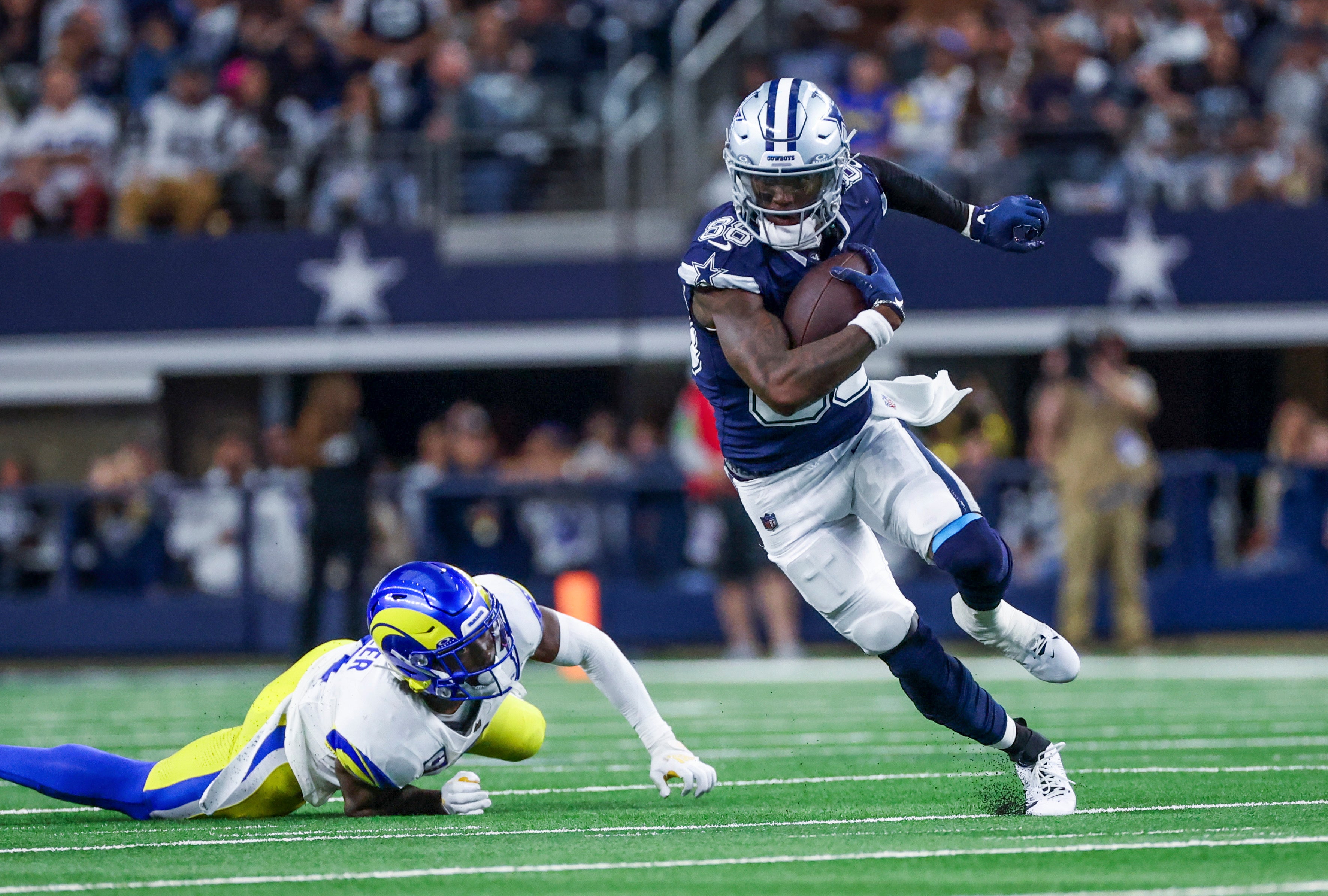 Dallas Cowboys wide receiver CeeDee Lamb (88) runs with the ball as Los Angeles Rams safety Jordan Fuller (4) defends during the first half at AT&T Stadium.