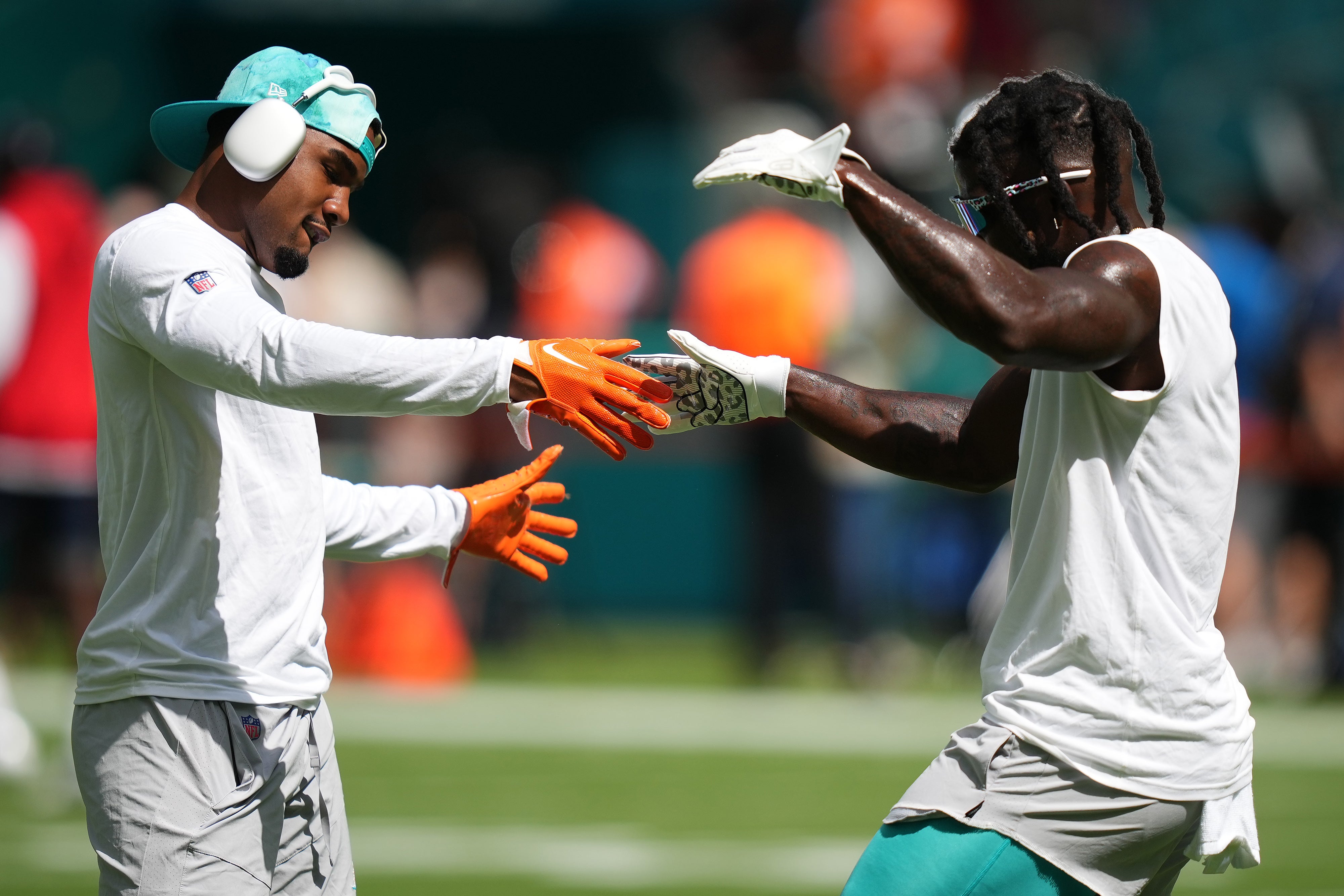 Sep 11, 2022; Miami Gardens, Florida, USA; Miami Dolphins wide receiver Jaylen Waddle (L) and wide receiver Tyreek Hill (R) celebrate while warming up for the game against the New England Patriots during the first half at Hard Rock Stadium.