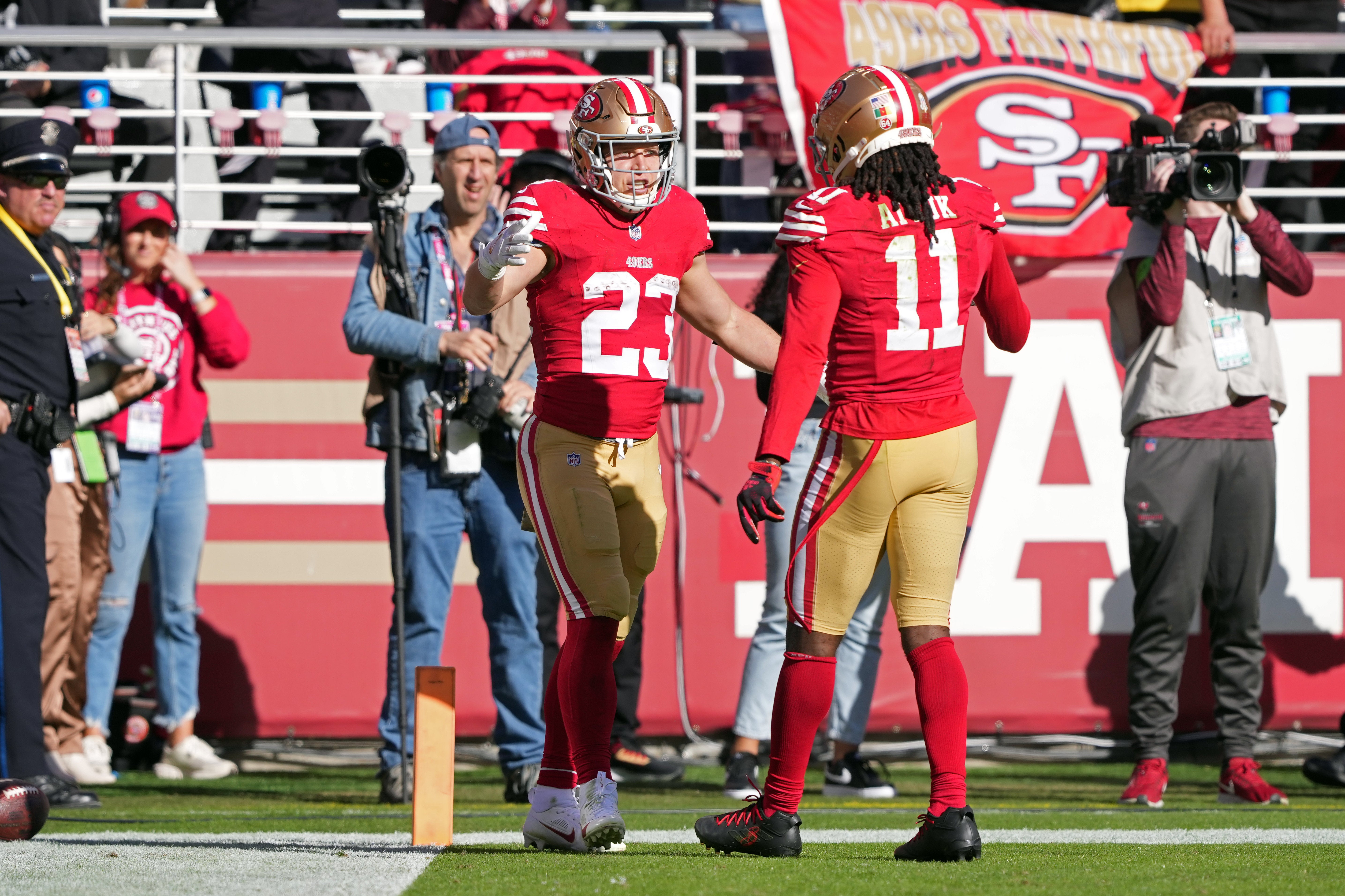 Nov 19, 2023; Santa Clara, California, USA; San Francisco 49ers running back Christian McCaffrey (23) celebrates with wide receiver Brandon Aiyuk (11) after scoring a touchdown against the Tampa Bay Buccaneers during the first quarter at Levi's Stadium.