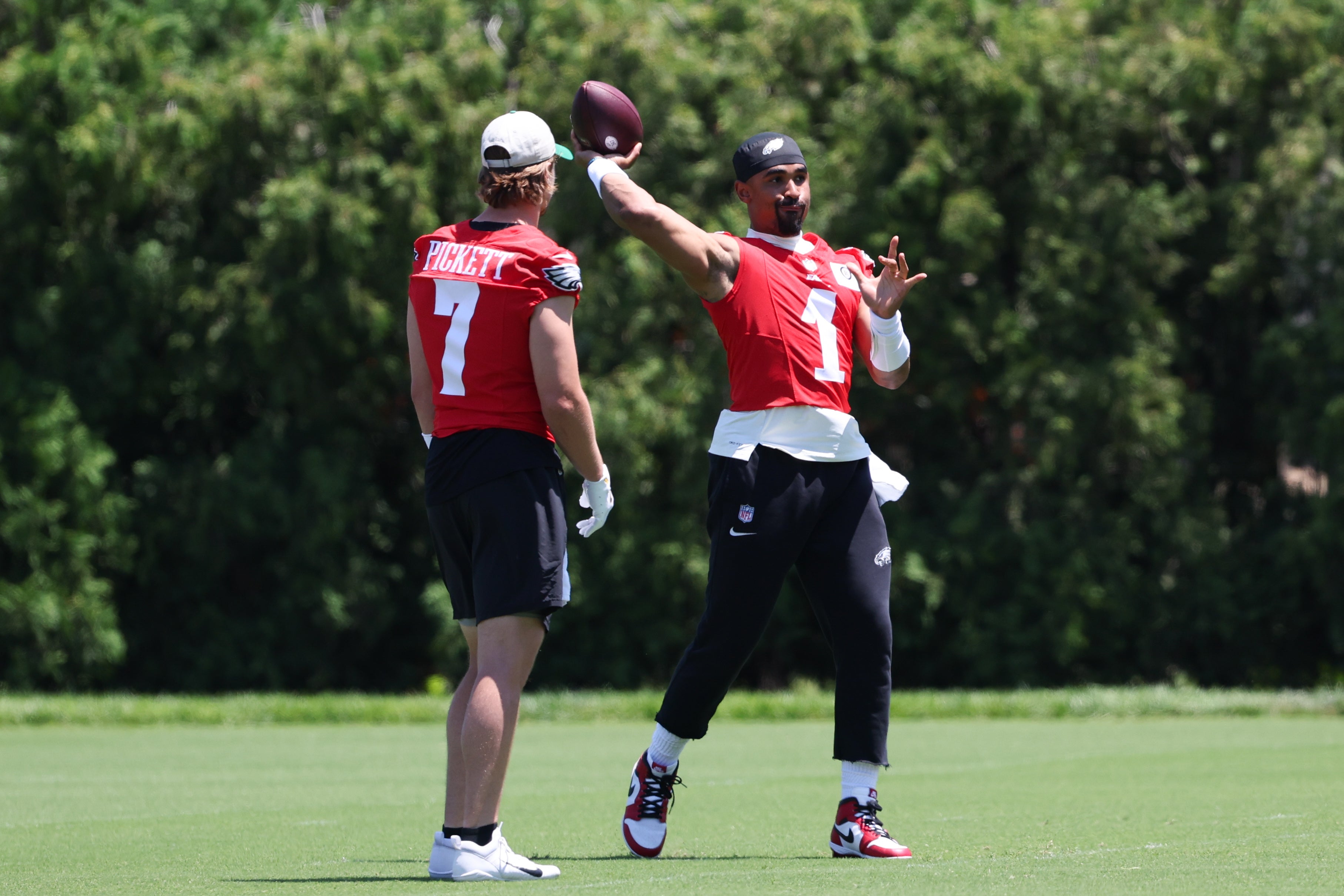 Philadelphia Eagles quarterback Jalen Hurts (1) throws the ball in front of quarterback Kenny Pickett (7) at NovaCare Complex.
