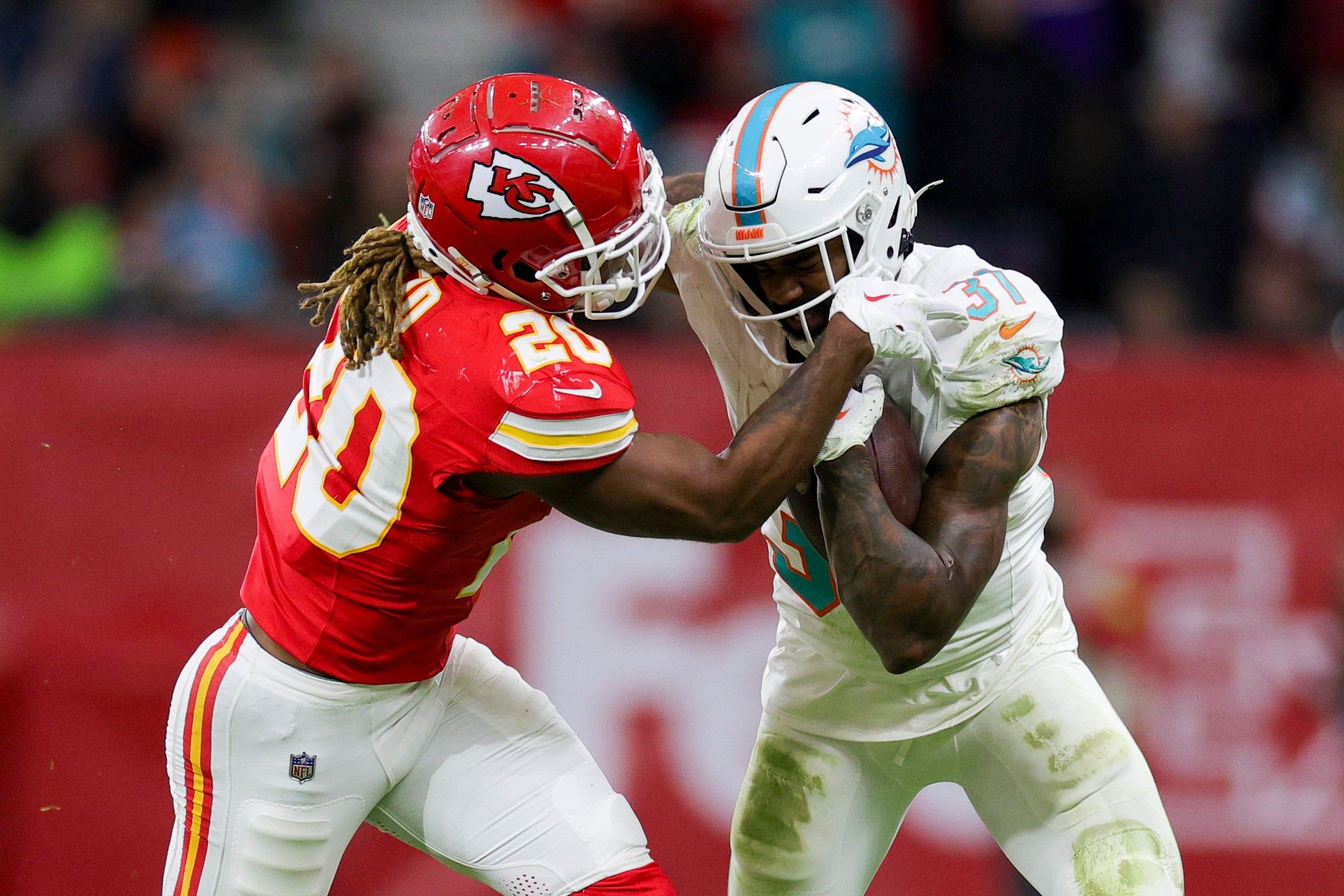 Nov 5, 2023; Frankfurt, Germany; Miami Dolphins running back Raheem Mostert (31) holds off Kansas City Chiefs safety Justin Reid (20) in the fourth quarter during an NFL International Series game at Deutsche Bank Park.
