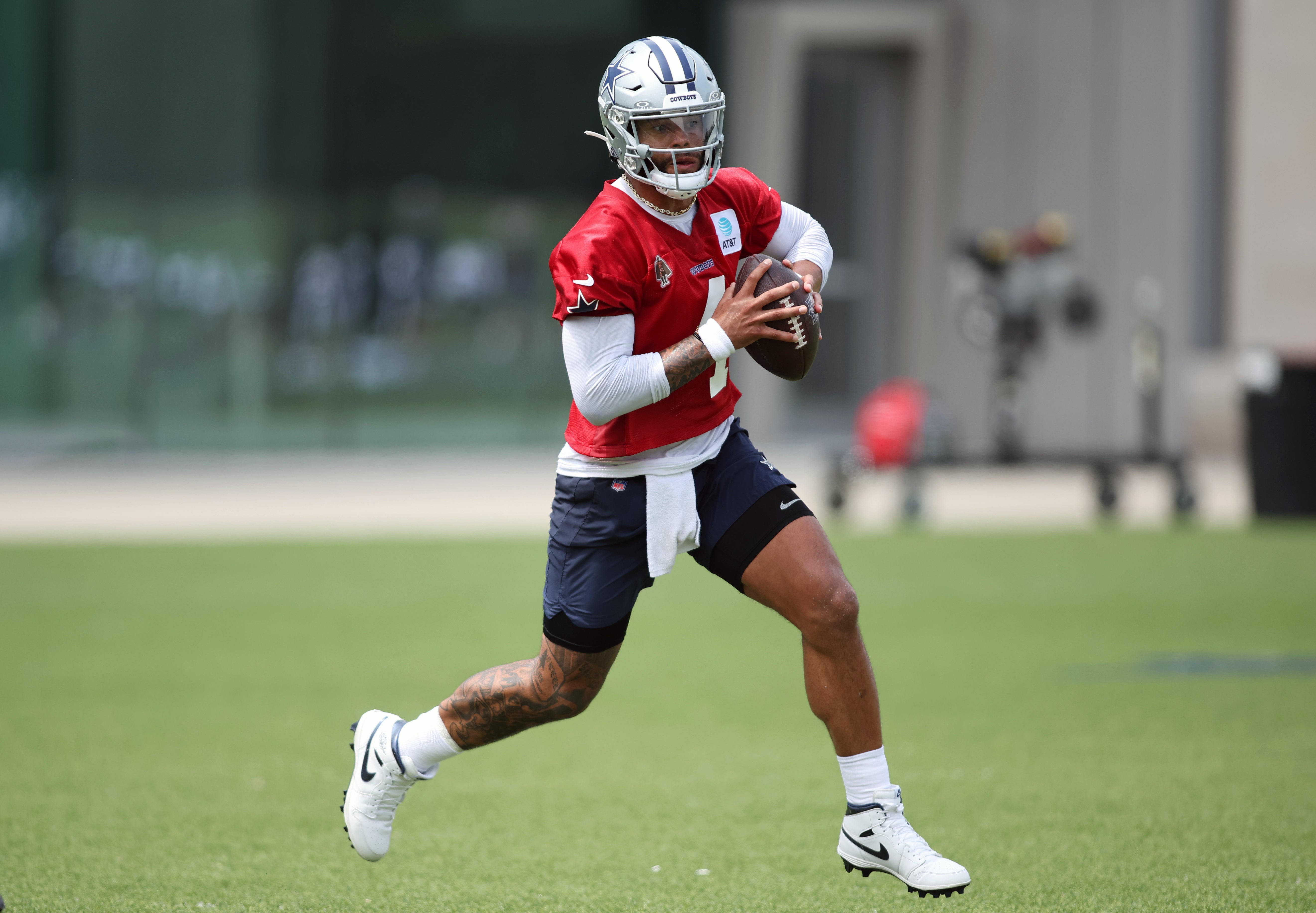 Dallas Cowboys quarterback Dak Prescott (4) goes through a drill during practice at the Ford Center at the Star Training Facility in Frisco, Texas.