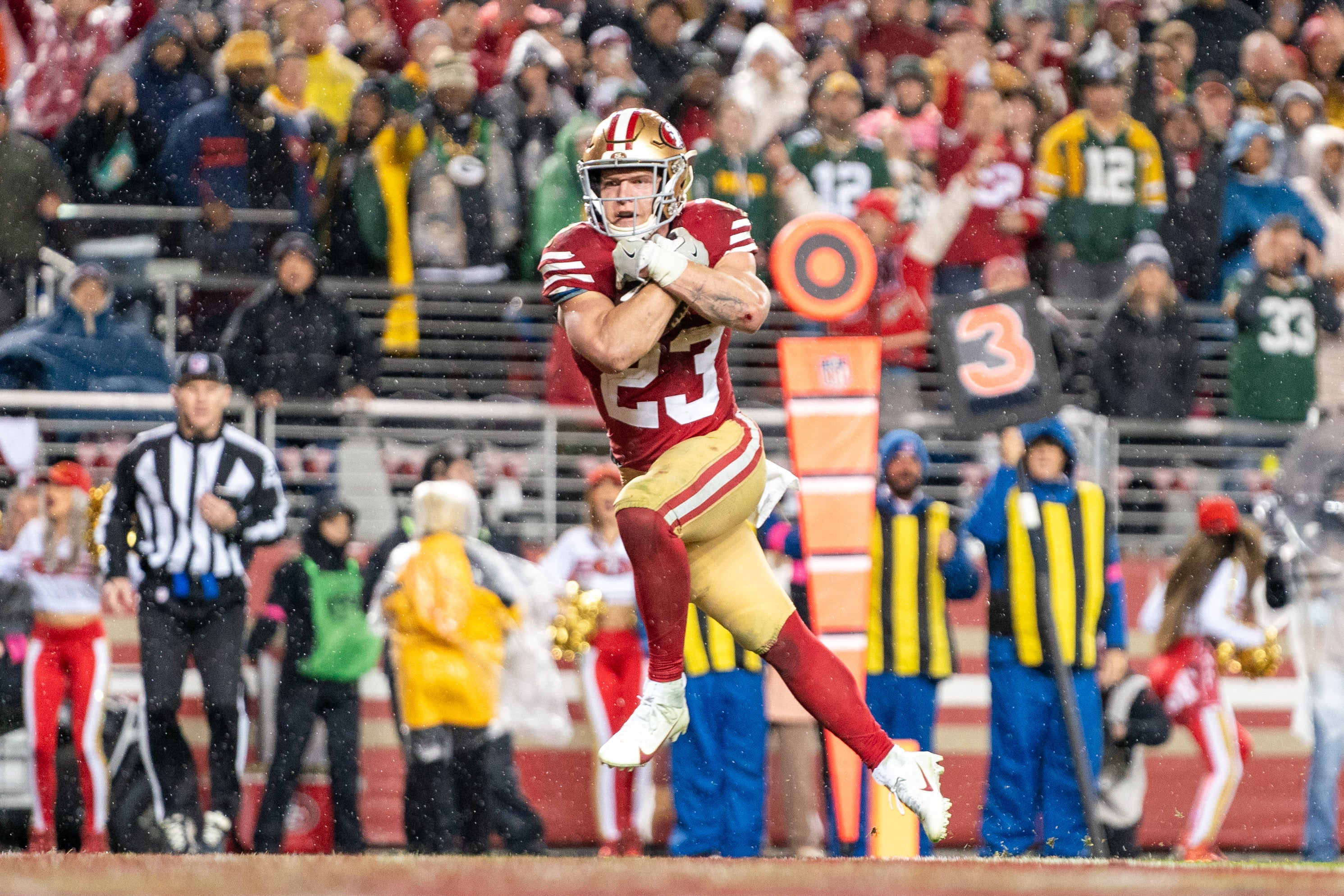 January 20, 2024; Santa Clara, CA, USA; San Francisco 49ers running back Christian McCaffrey (23) scores a touchdown during the fourth quarter in a 2024 NFC divisional round game against the Green Bay Packers at Levi's Stadium.