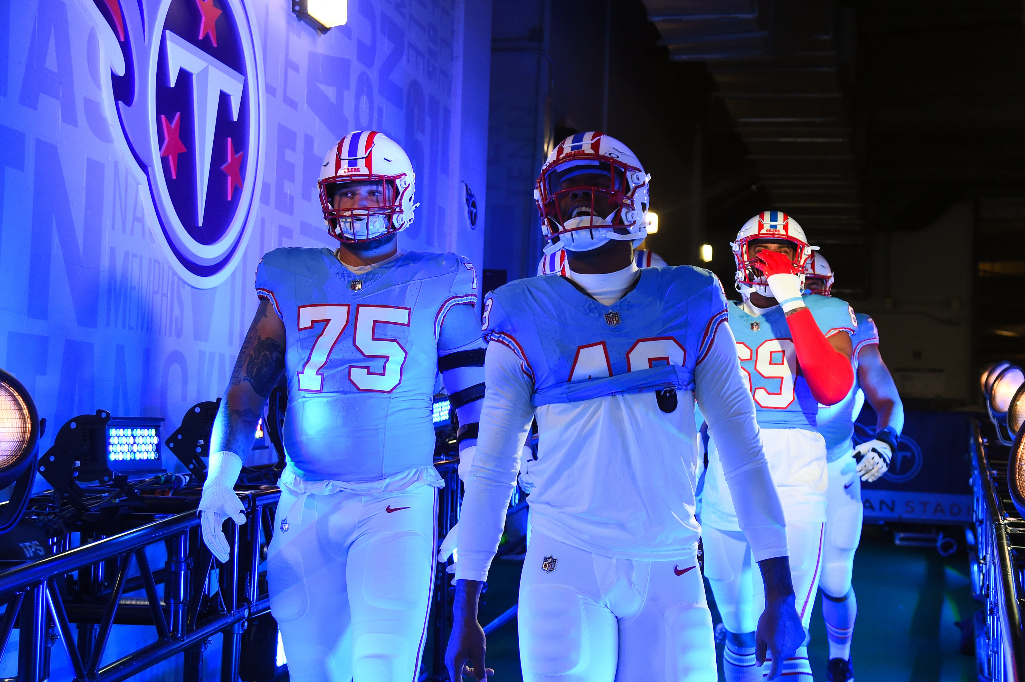 Dec 17, 2023; Nashville, Tennessee, USA; Tennessee Titans linebacker Arden Key (49) and offensive tackle Dillon Radunz (75) walk to the field before the game against the Houston Texans at Nissan Stadium.