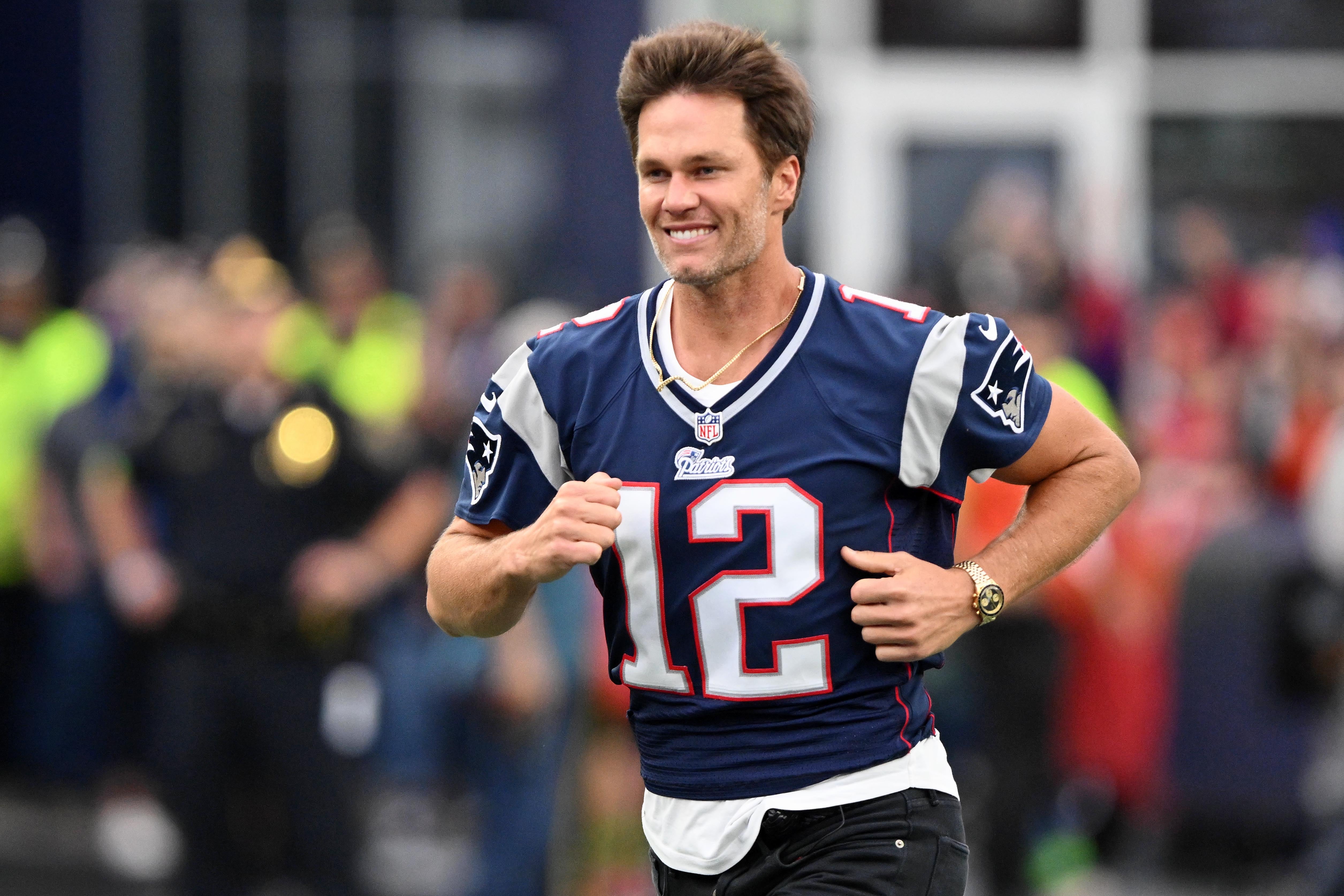 Sep 10, 2023; Foxborough, Massachusetts, USA; New England Patriots former quarterback Tom Brady runs on the field during a halftime ceremony in his honor during the game between the Philadelphia Eagles and New England Patriots at Gillette Stadium.