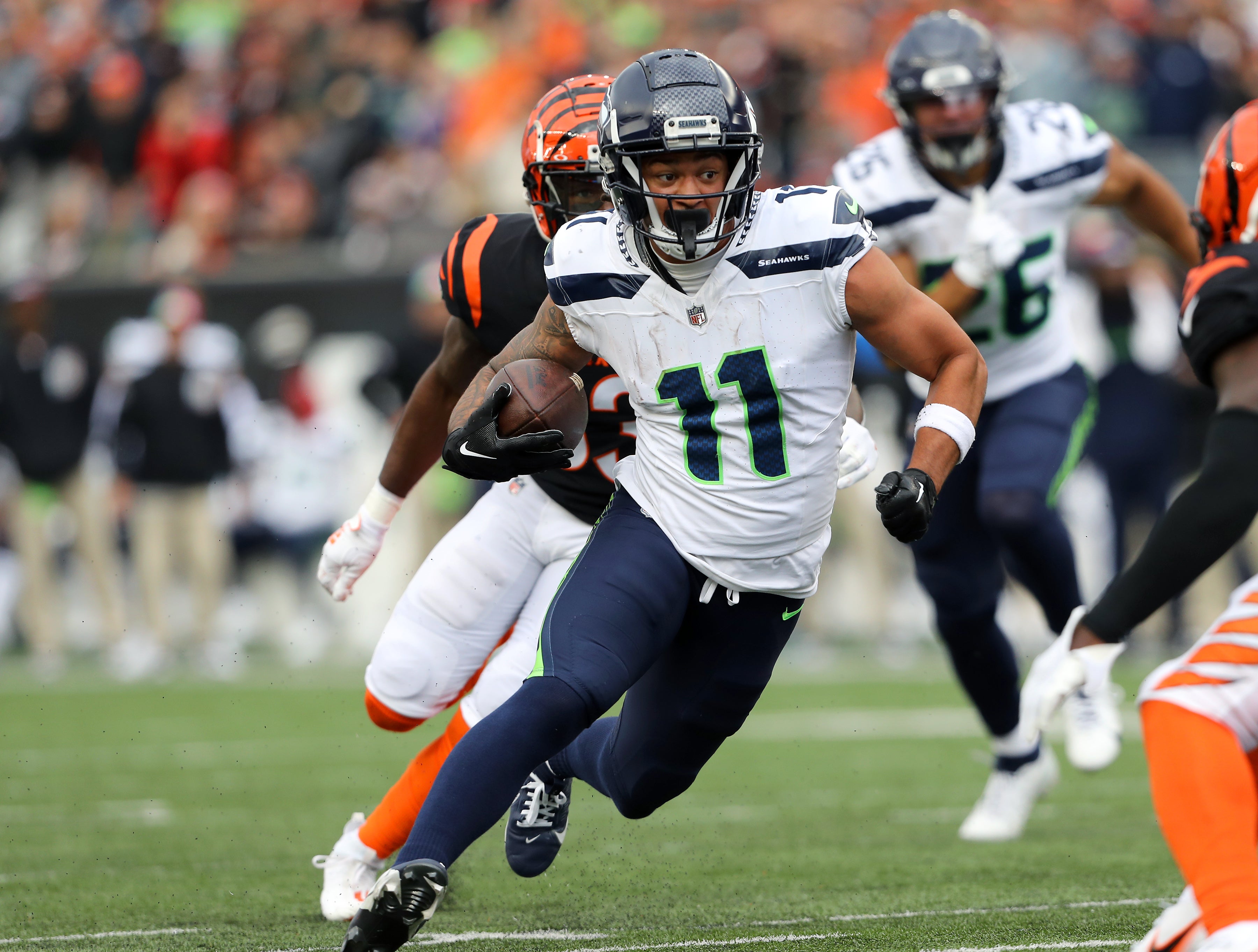 Oct 15, 2023; Cincinnati, Ohio, USA; Seattle Seahawks wide receiver Jaxon Smith-Njigba (11) runs after the catch as Cincinnati Bengals safety Nick Scott (33) defends during the fourth quarter at Paycor Stadium.