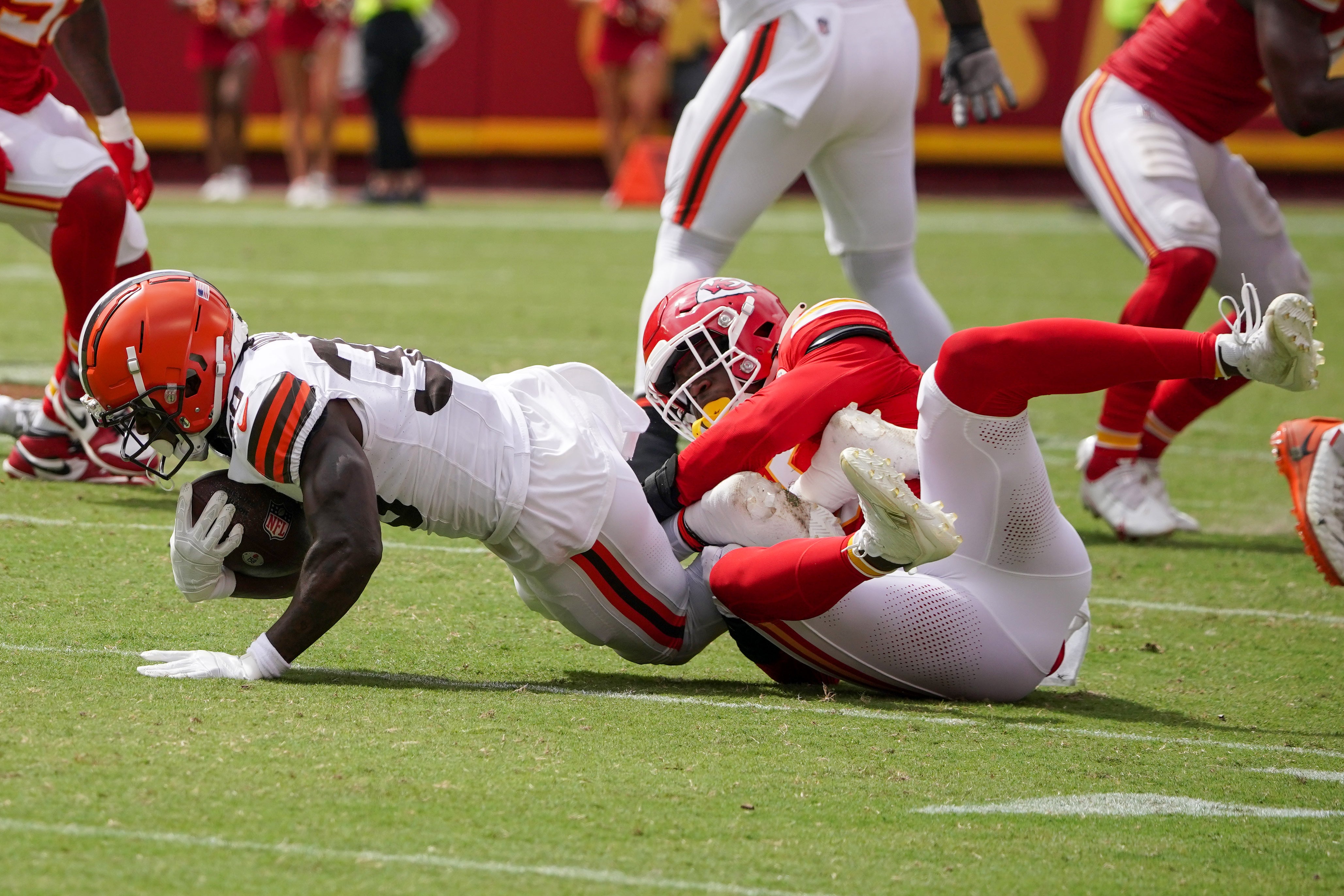 Aug 26, 2023; Kansas City, Missouri, USA; Cleveland Browns running back Hassan Hall (30) is tackled by Kansas City Chiefs defensive end Joshua Kaindoh (59) during the second half at GEHA Field at Arrowhead Stadium.