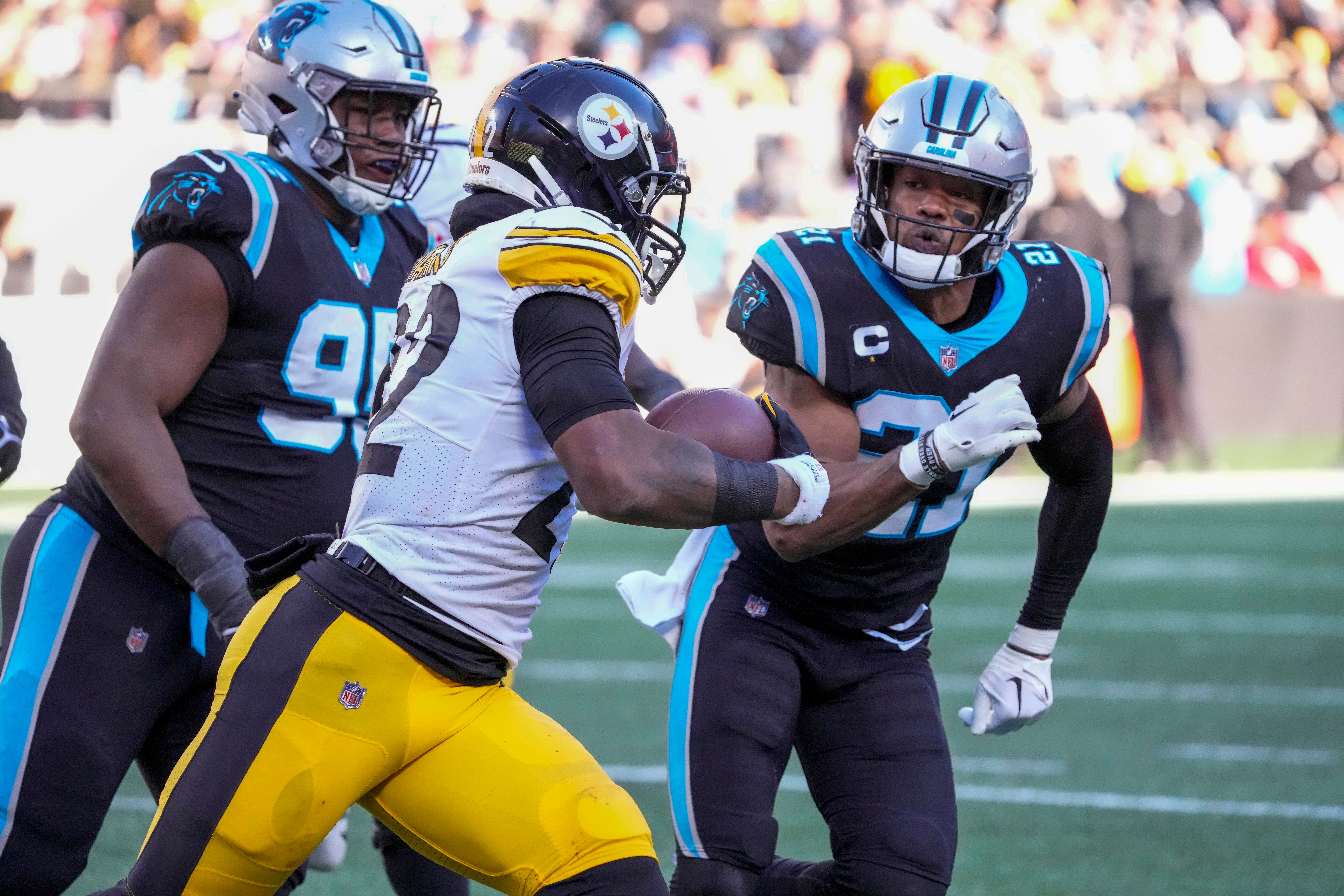 Dec 18, 2022; Charlotte, North Carolina, USA; Pittsburgh Steelers running back Najee Harris (22) is chased down by Carolina Panthers defensive tackle Derrick Brown (95) and safety Jeremy Chinn (21) during the second half at Bank of America Stadium. Mandatory Credit: Jim Dedmon-USA TODAY Sports  