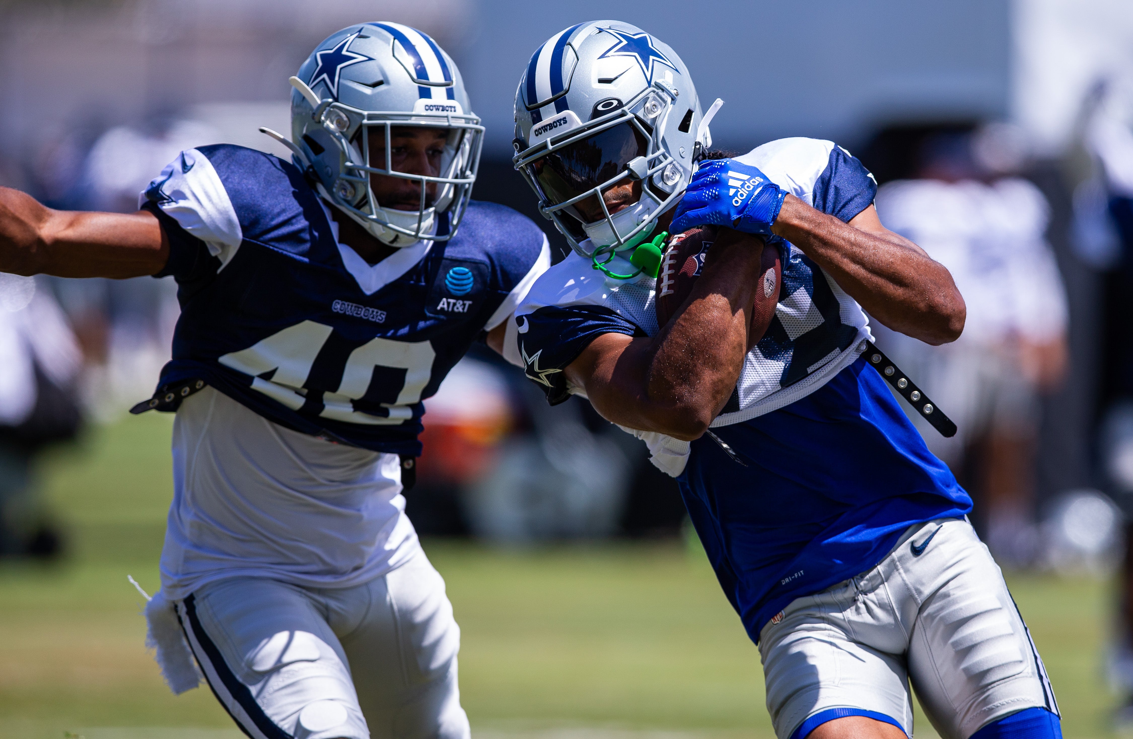 Dallas Cowboys wide receiver Jalen Tolbert (18) keeps the ball from safety Juanyeh Thomas (40) during training camp at Marriott Residence Inn-River Ridge playing fields.