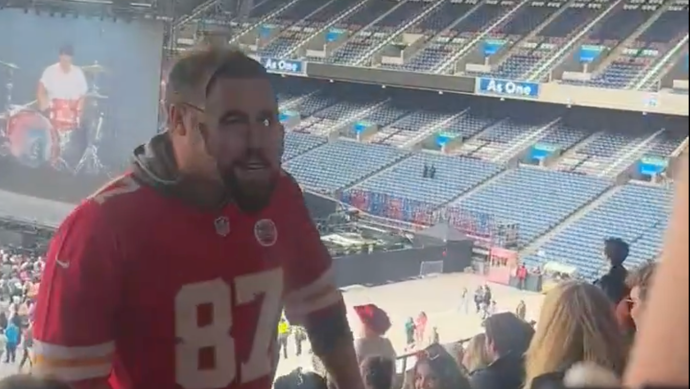 A fan arrives at Taylor Swift's Eras Tour in a Travis Kelce mask