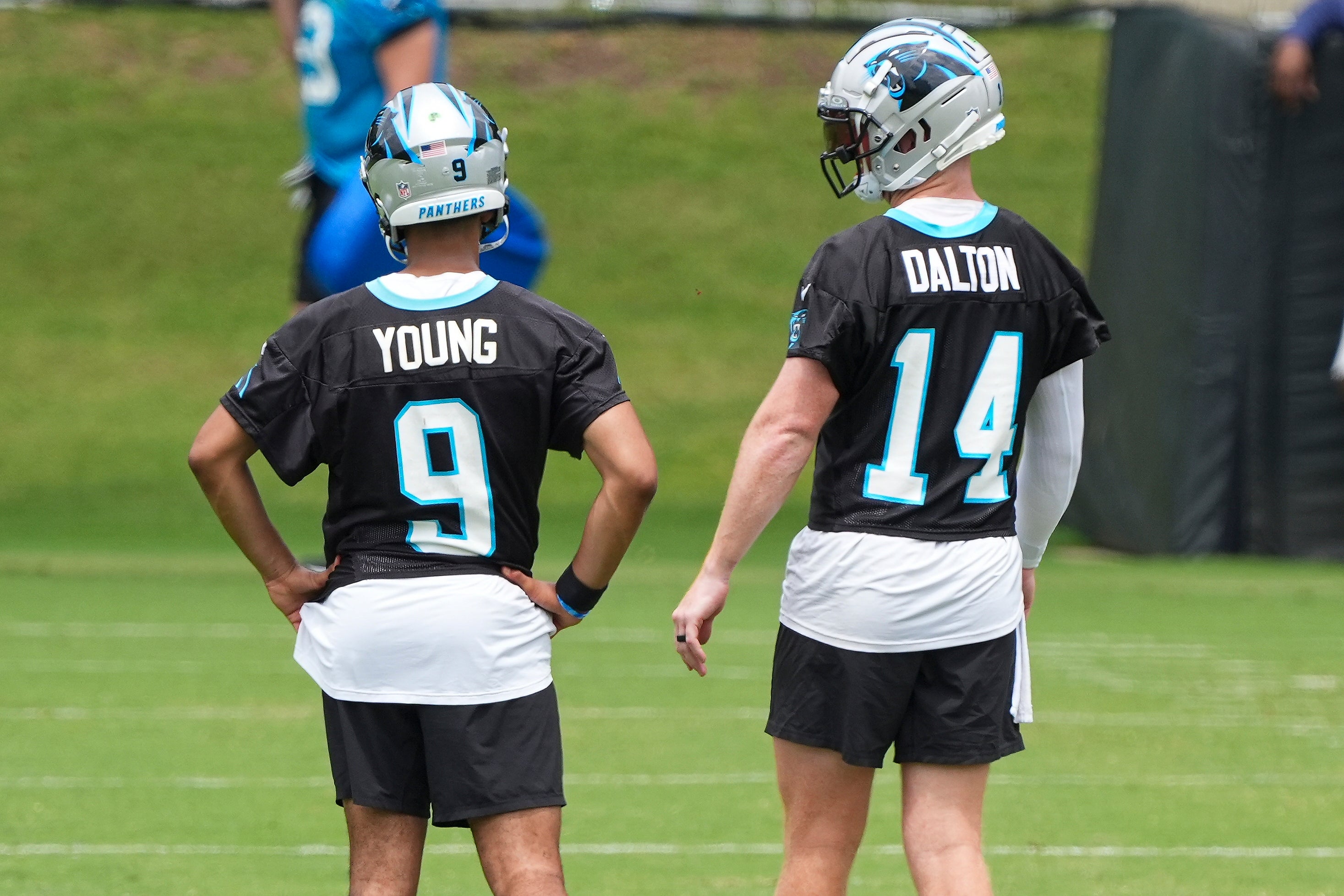 Jun 4, 2024; Charlotte, NC, USA; Carolina Panthers quarterback Bryce Young (9) and quarterback Andy Dalton (14) chat during OTAs. Mandatory Credit: Jim Dedmon-USA TODAY Sports