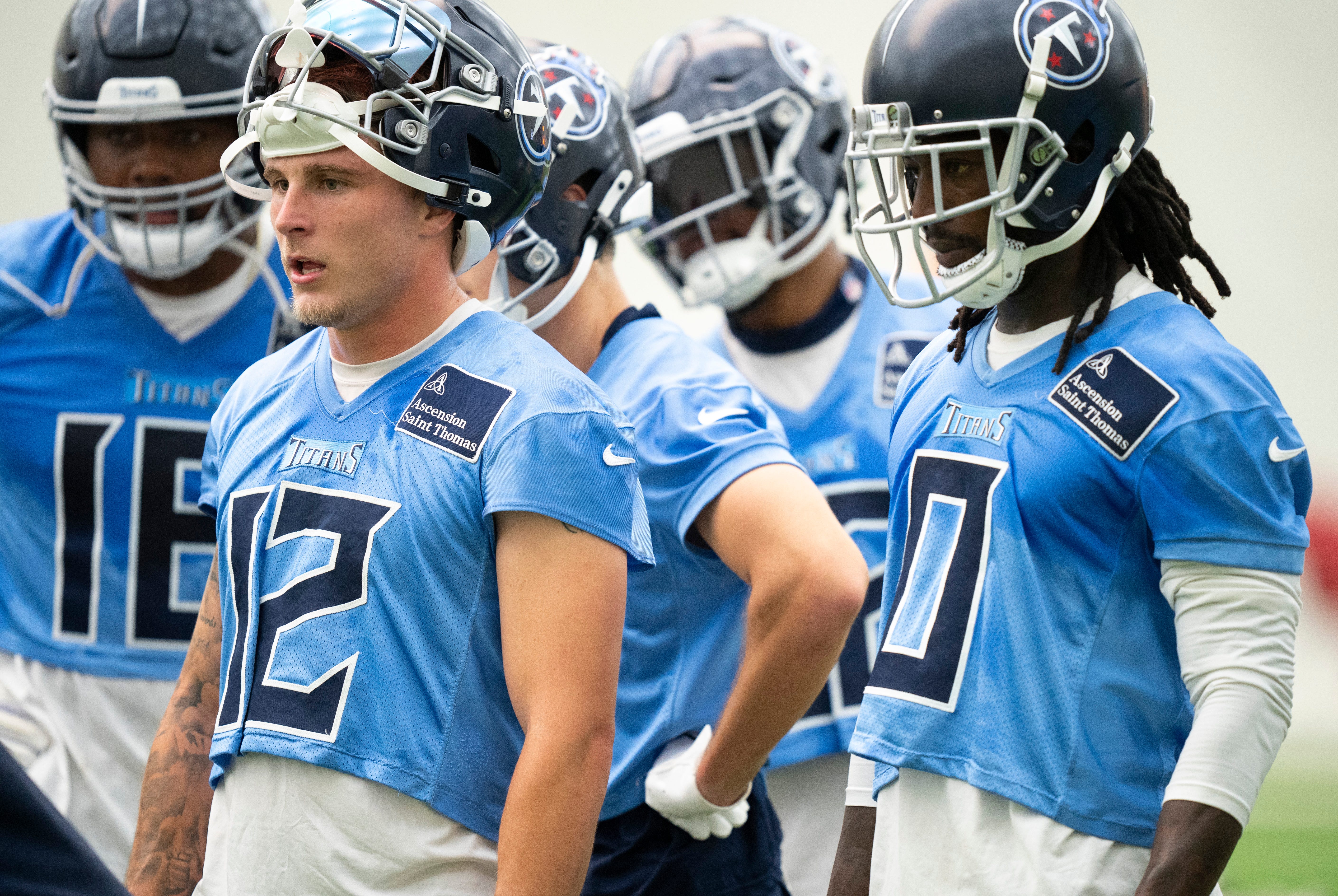 Wide receivers Mason Kinsey (12) and Calvin Ridley (0) listen to wide receivers coach Tyke Tolbert during the Tennessee Titans mandatory mini-camp at Ascension Saint Thomas Sports Park in Nashville, Tenn., Tuesday, June 4, 2024.