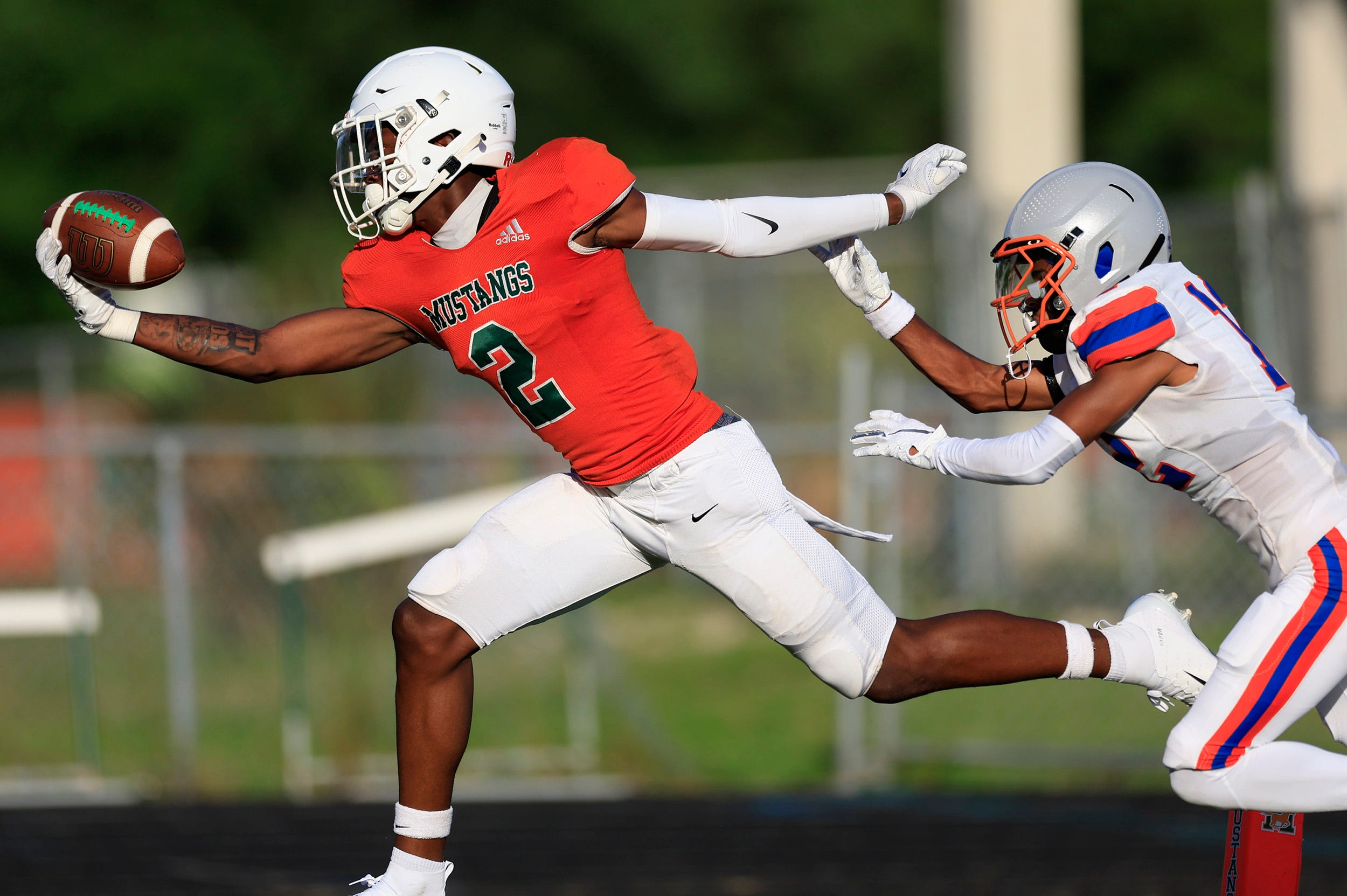 Mandarin's Jaime Ffrench (2) makes a one-handed touchdown reception against Bolles' Santana Starks (12) during the first quarter of a high school football matchup Thursday, May 23, 2024 at Mandarin High School in Jacksonville, Fla. Mandarin defeated Bolles 35-14.