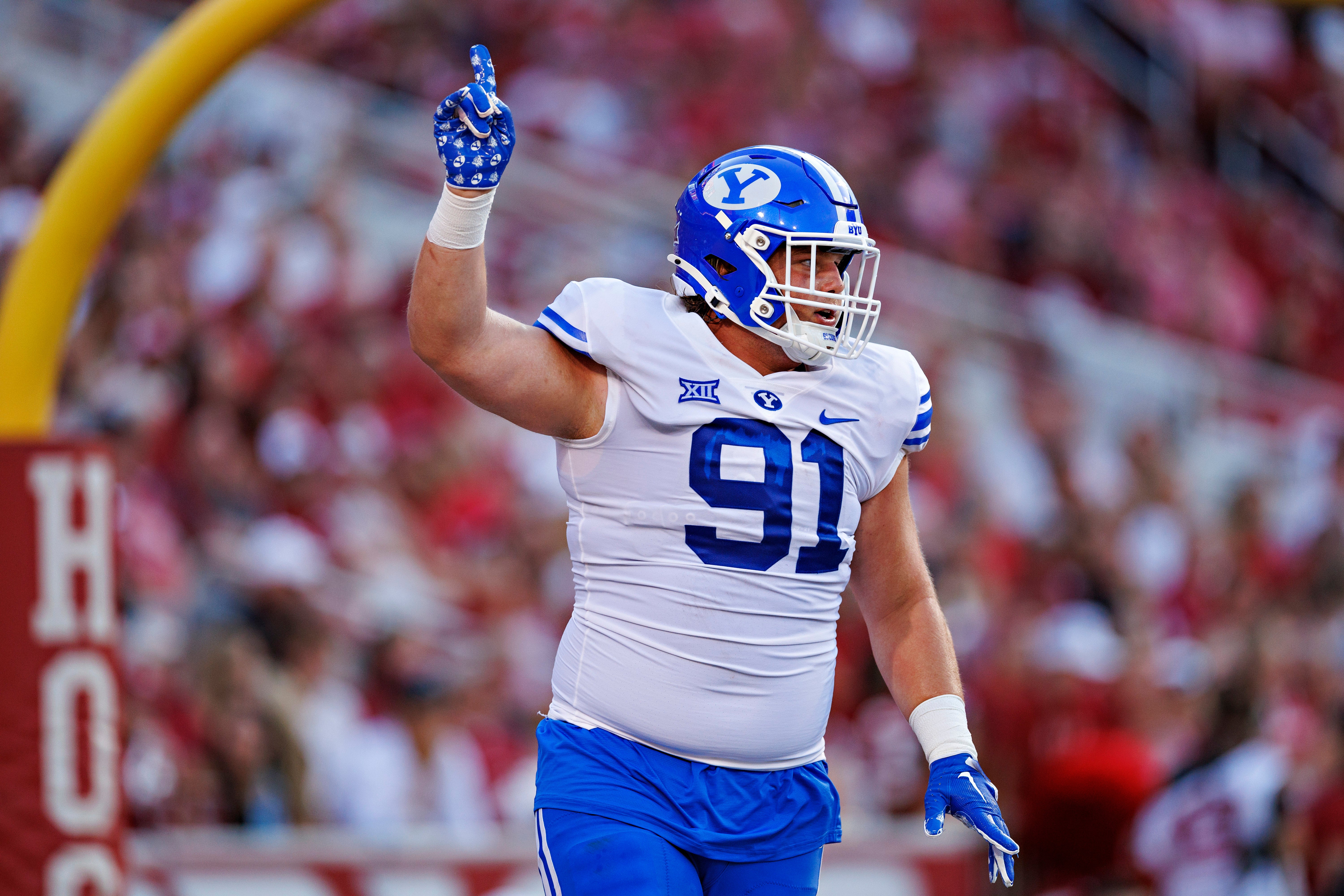 FAYETTEVILLE, ARKANSAS - SEPTEMBER 16: Jackson Cravens #91 of the BYU Cougars celebrates after his team scored a touchdown in the first half of the game against the Arkansas Razorbacks at Donald W. Reynolds Razorback Stadium on September 16, 2023 in Fayetteville, Arkansas.