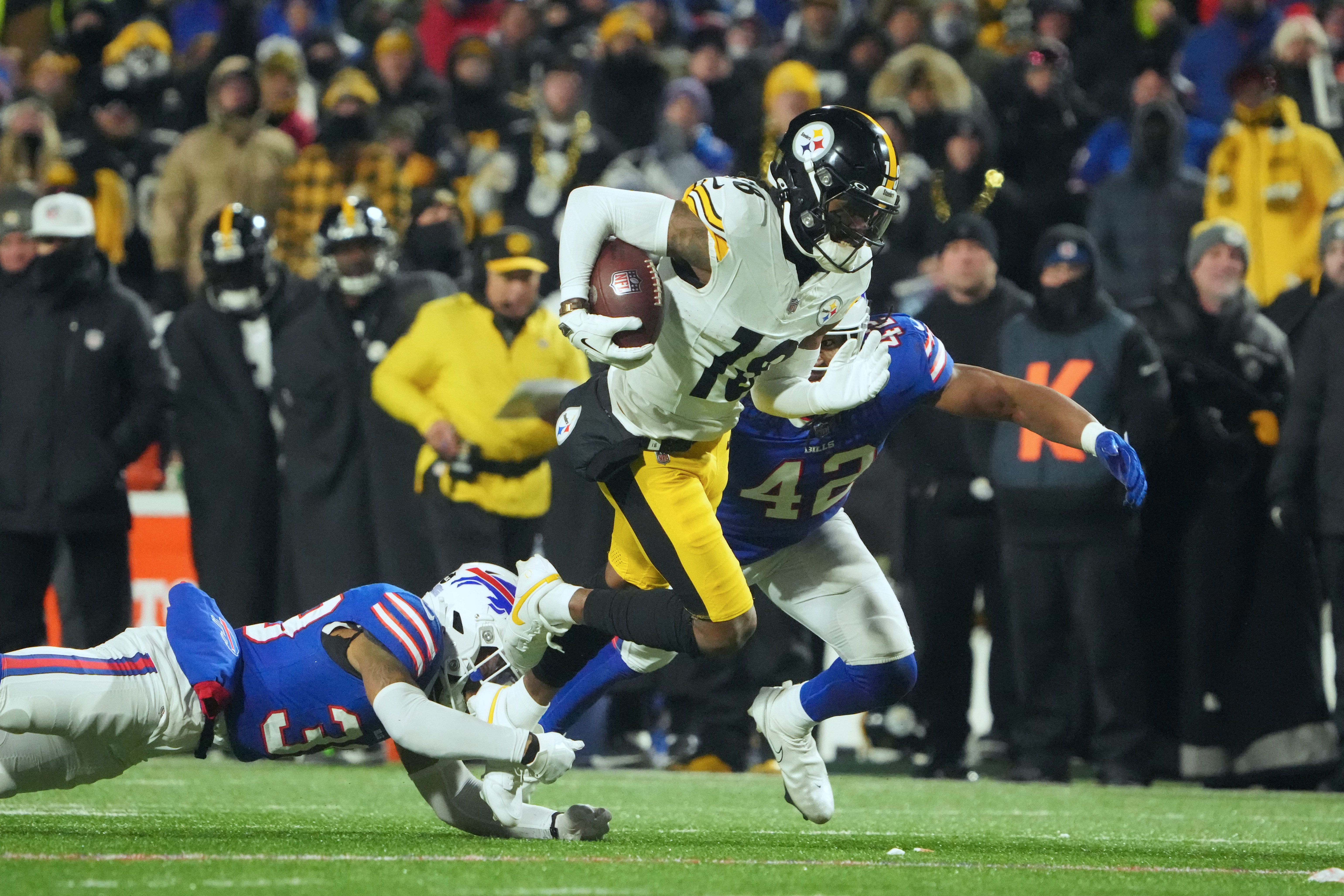 Jan 15, 2024; Orchard Park, New York, USA; Buffalo Bills cornerback Cam Lewis (39) attempts to tackle Pittsburgh Steelers wide receiver Diontae Johnson (18) in the second half in the second half in a 2024 AFC wild card game at Highmark Stadium. Mandatory Credit: Kirby Lee-USA TODAY Sports