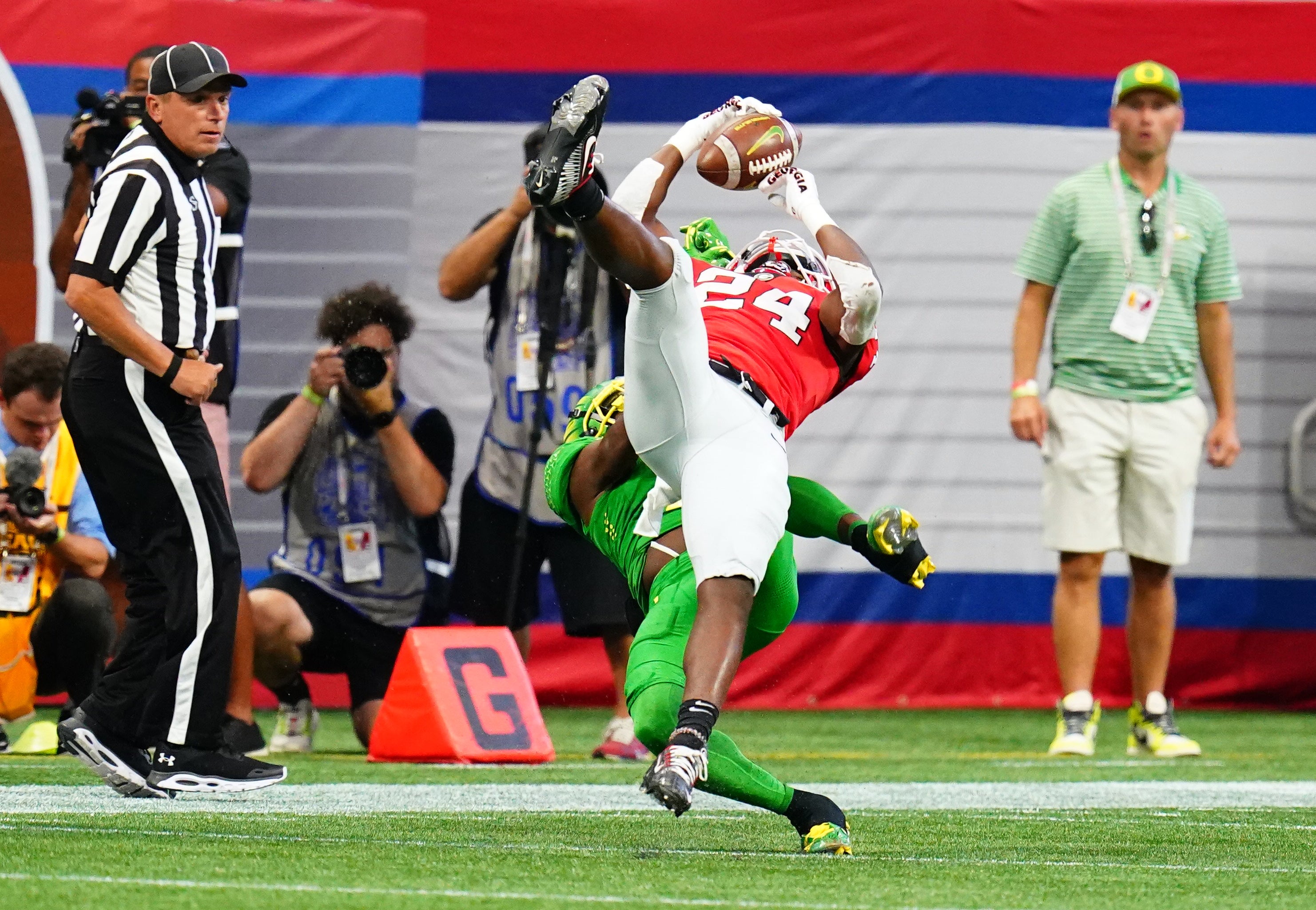 Sep 3, 2022; Atlanta, Georgia, USA; Georgia Bulldogs defensive back Malaki Starks (24) pulls down an interception against Oregon Ducks wide receiver Seven McGee (7) during the first quarter of the Chick-fil-A kickoff game at Mercedes-Benz Stadium.