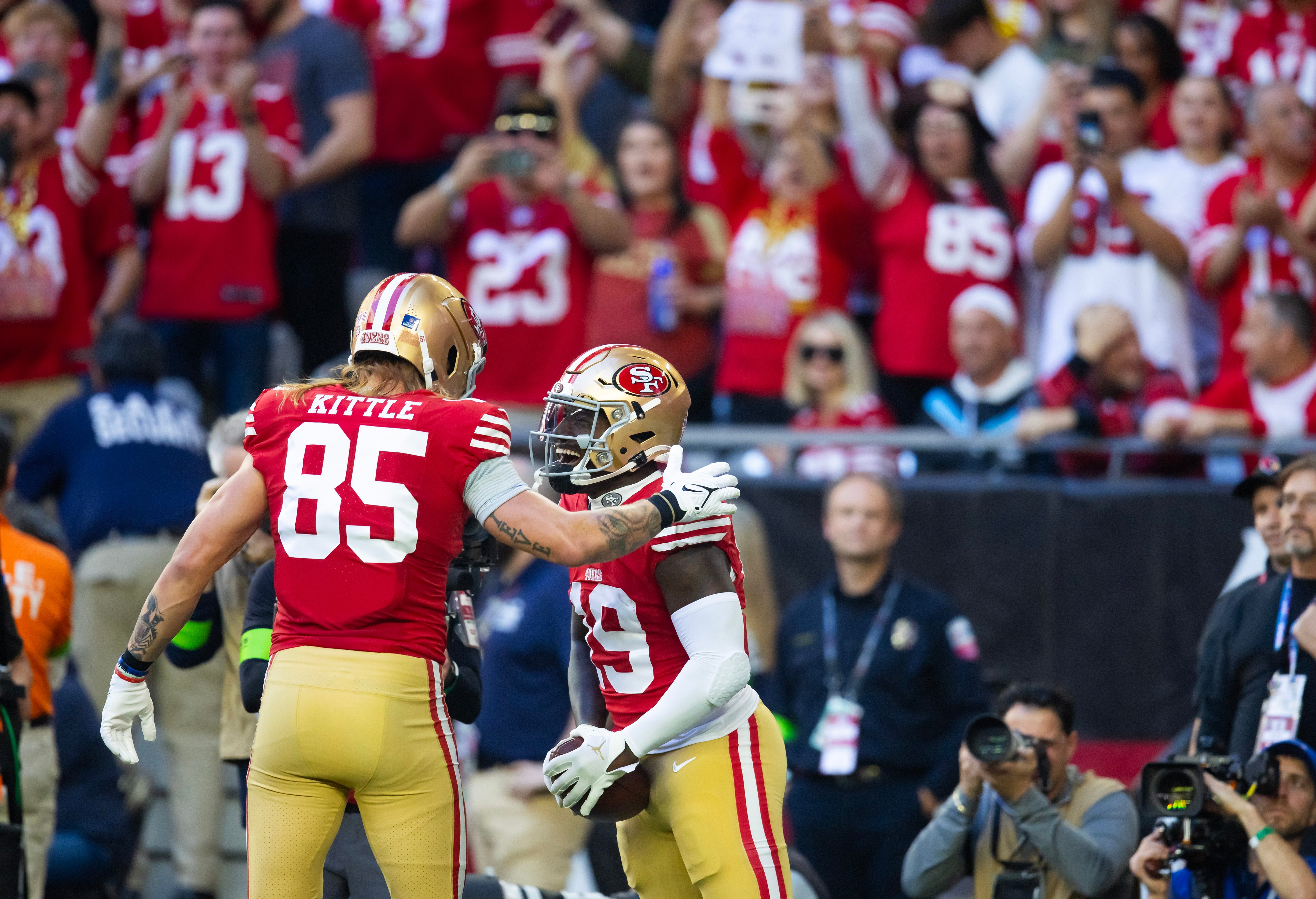 Dec 17, 2023; Glendale, Arizona, USA; San Francisco 49ers wide receiver Deebo Samuel (19) celebrates a touchdown with tight end George Kittle (85) against the Arizona Cardinals at State Farm Stadium.
