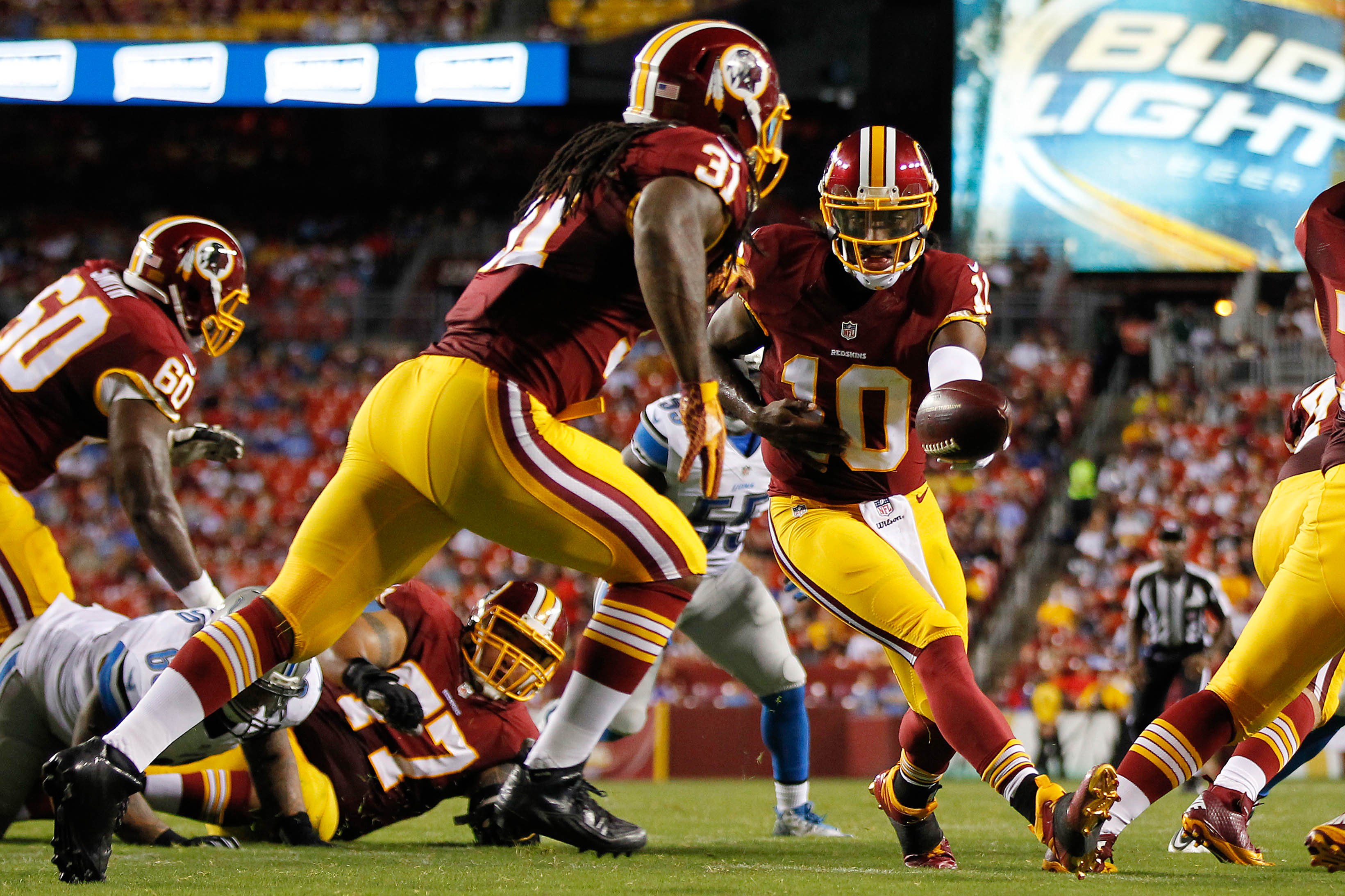 Washington Redskins quarterback Robert Griffin III (10) hands the ball off to Redskins running back Matt Jones (31) against the Detroit Lions at FedEx Field.