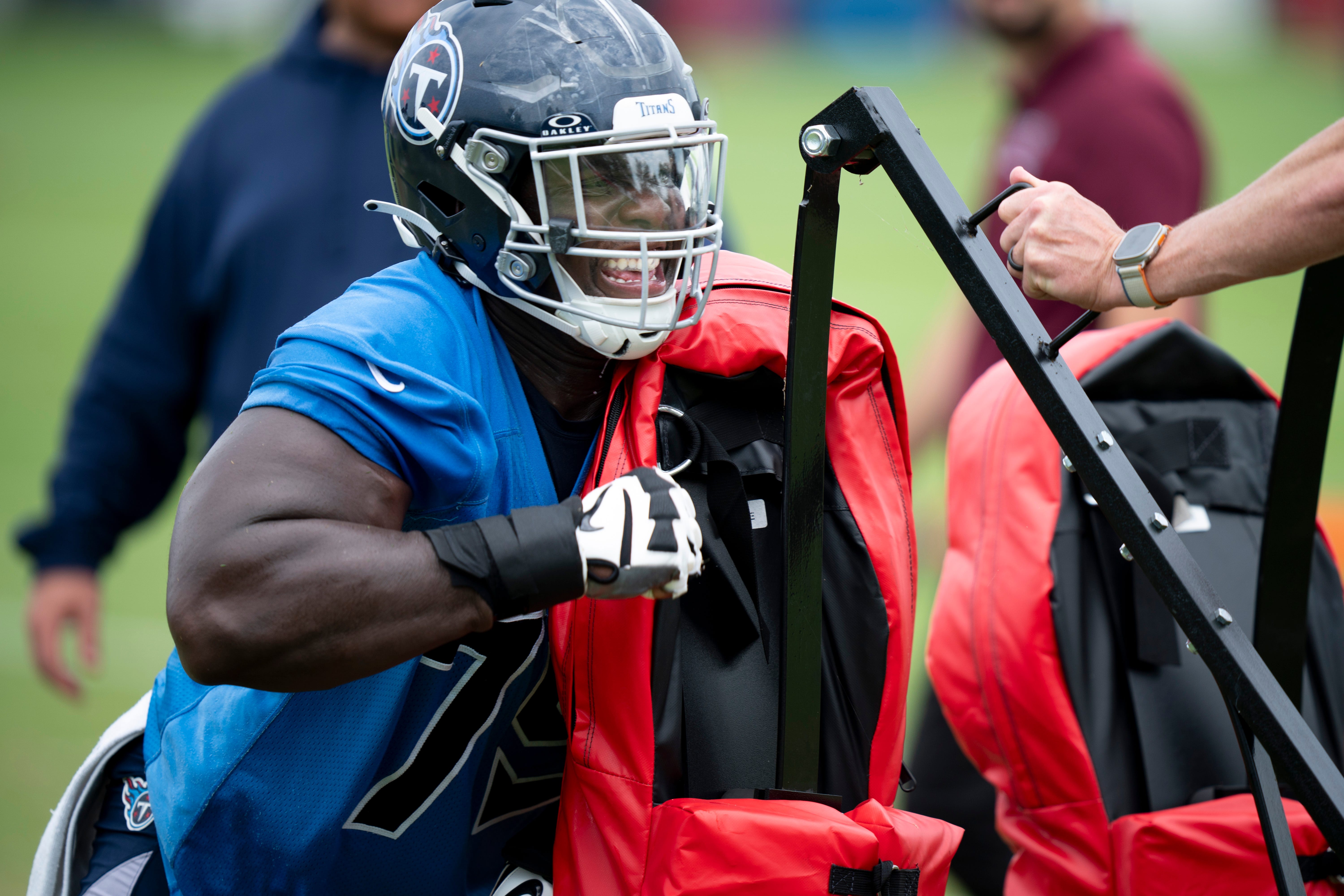 Center Lloyd Cushenberry III hits the sled during drills during the Tennessee Titans mandatory mini-camp at Ascension Saint Thomas Sports Park in Nashville, Tenn., Wednesday, June 5, 2024.