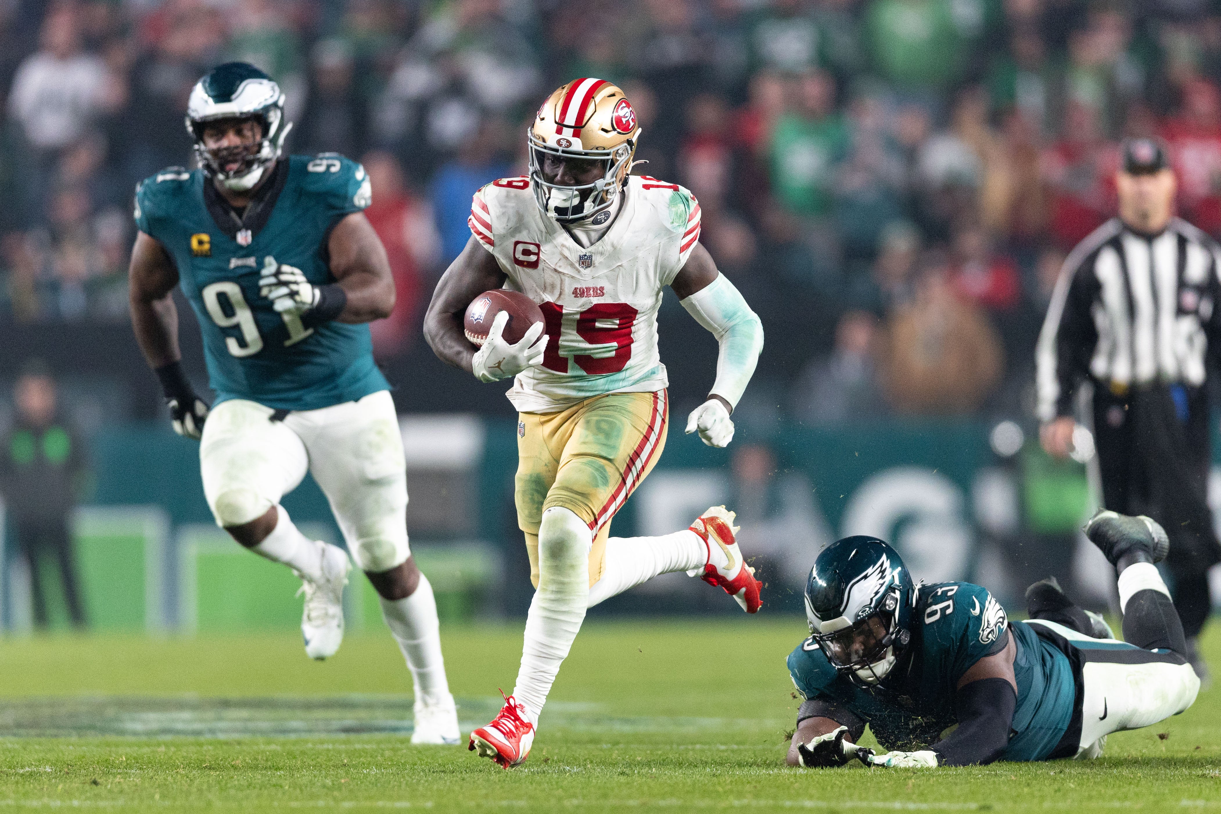 Dec 3, 2023; Philadelphia, Pennsylvania, USA; San Francisco 49ers wide receiver Deebo Samuel (19) eludes the tackle attempt of Philadelphia Eagles defensive tackle Milton Williams (93) on his way to scoring a touchdown during the fourth quarter at Lincoln Financial Field.
