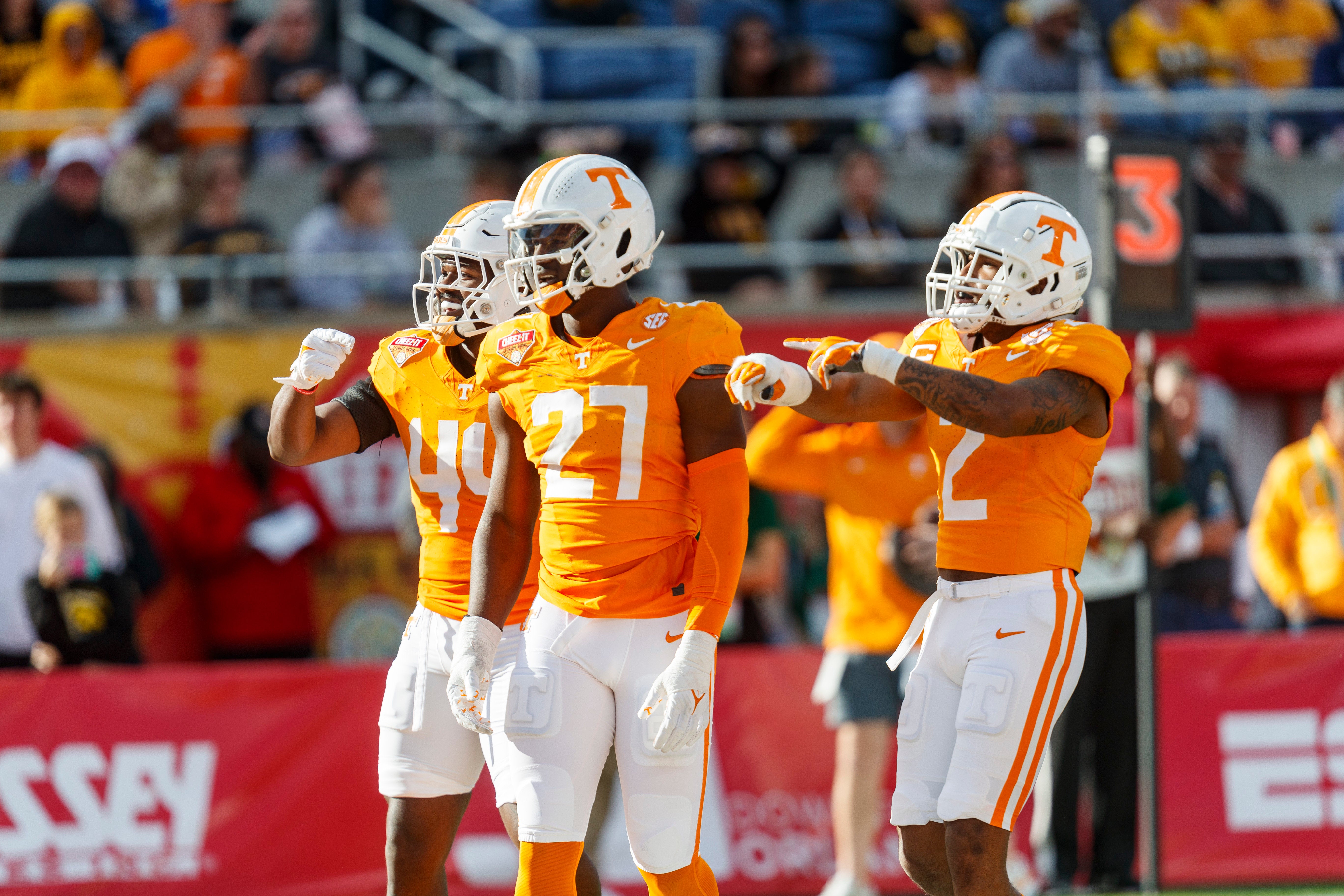 Jan 1, 2024; Orlando, FL, USA; Tennessee Volunteers defensive lineman James Pearce Jr. (27), linebacker Elijah Herring (44) and defensive back Jaylen McCollough (2) celebrate a sack against the Iowa Hawkeyes during the third quarter at Camping World Stadium.