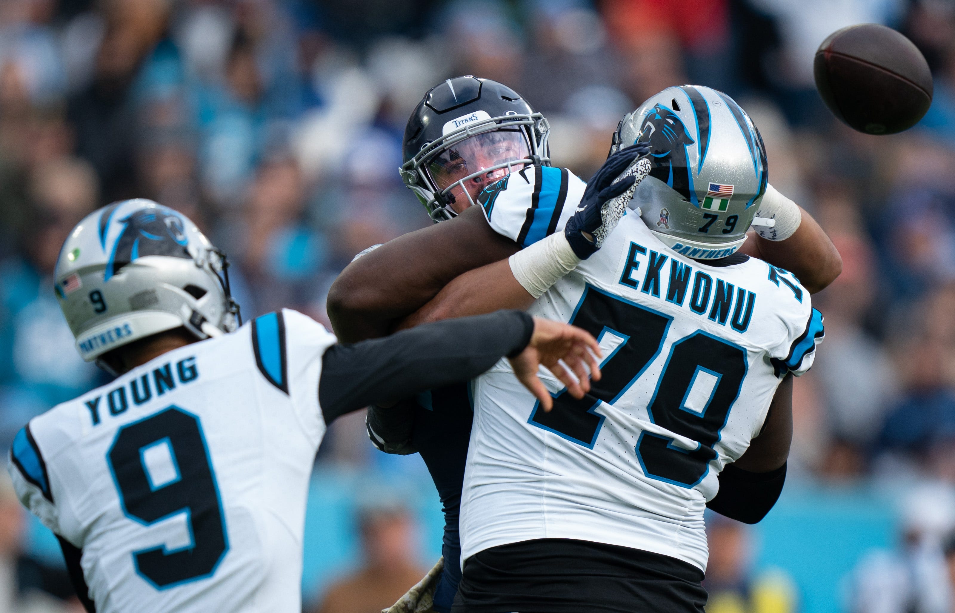Tennessee Titans linebacker Rashad Weaver (99) puts pressure on Carolina Panthers quarterback Bryce Young (9) as offensive tackle Ikem Ekwonu (79) tries to hold him off during their game at Nissan Stadium in Nashville, Tenn., Sunday, Nov. 26, 2023.