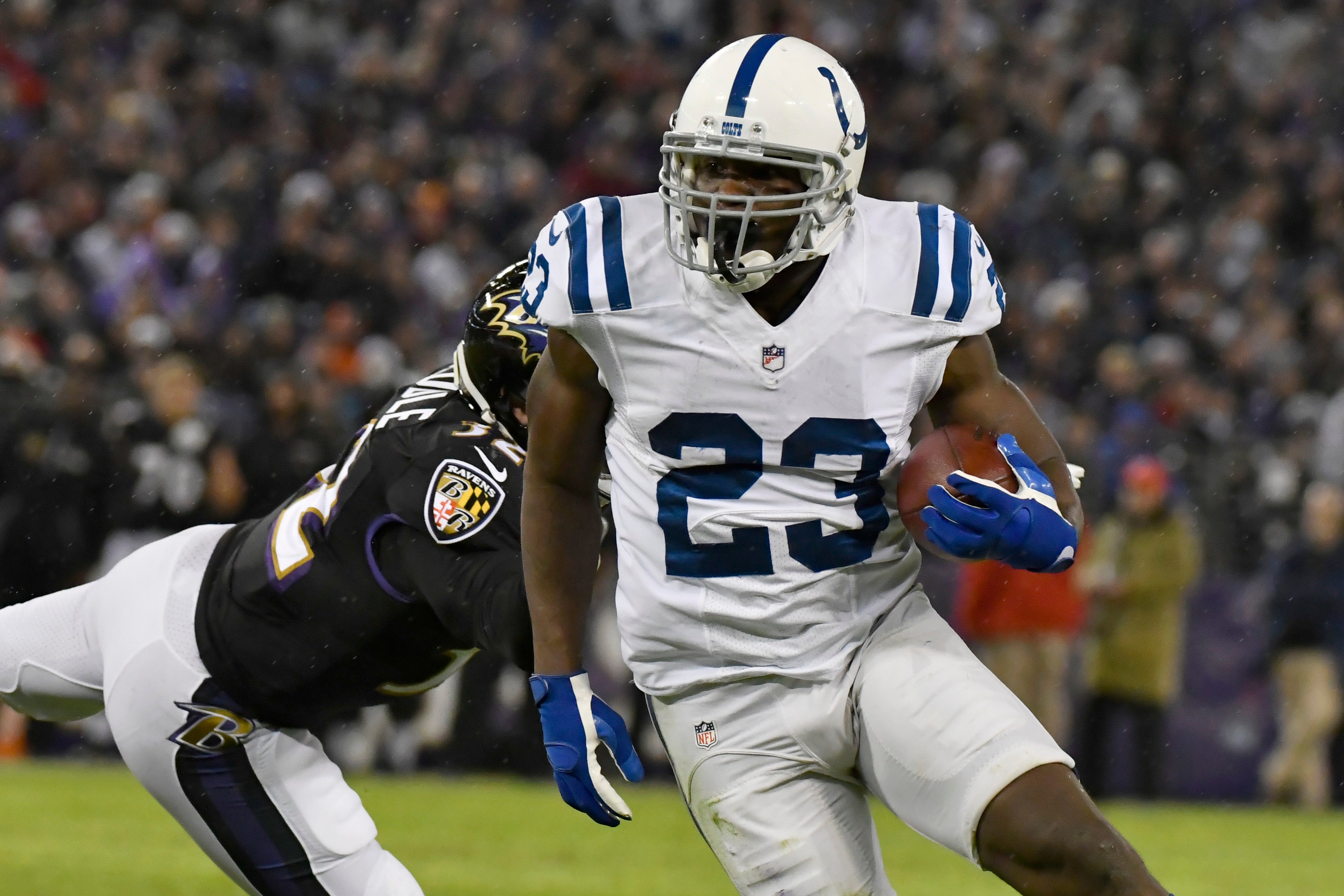 Dec 23, 2017; Baltimore, MD, USA; Indianapolis Colts running back Frank Gore (23) runs past Baltimore Ravens safety Eric Weddle (32) during the second quarter at M&T Bank Stadium.