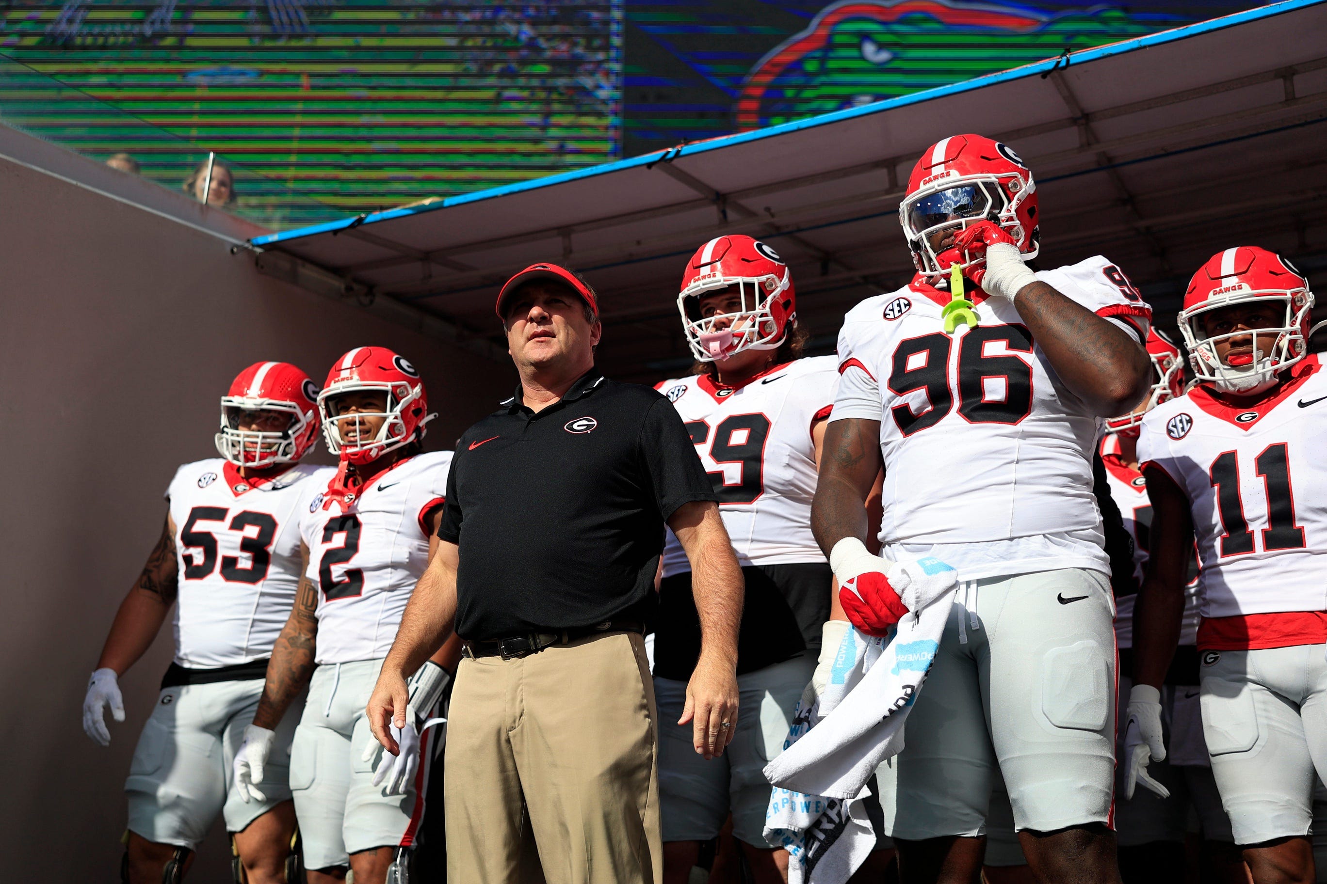 Georgia Bulldogs head coach Kirby Smart, center, prepares to lead, from left, offensive lineman Dylan Fairchild (53), running back Kendall Milton (2), offensive lineman Tate Ratledge (69).