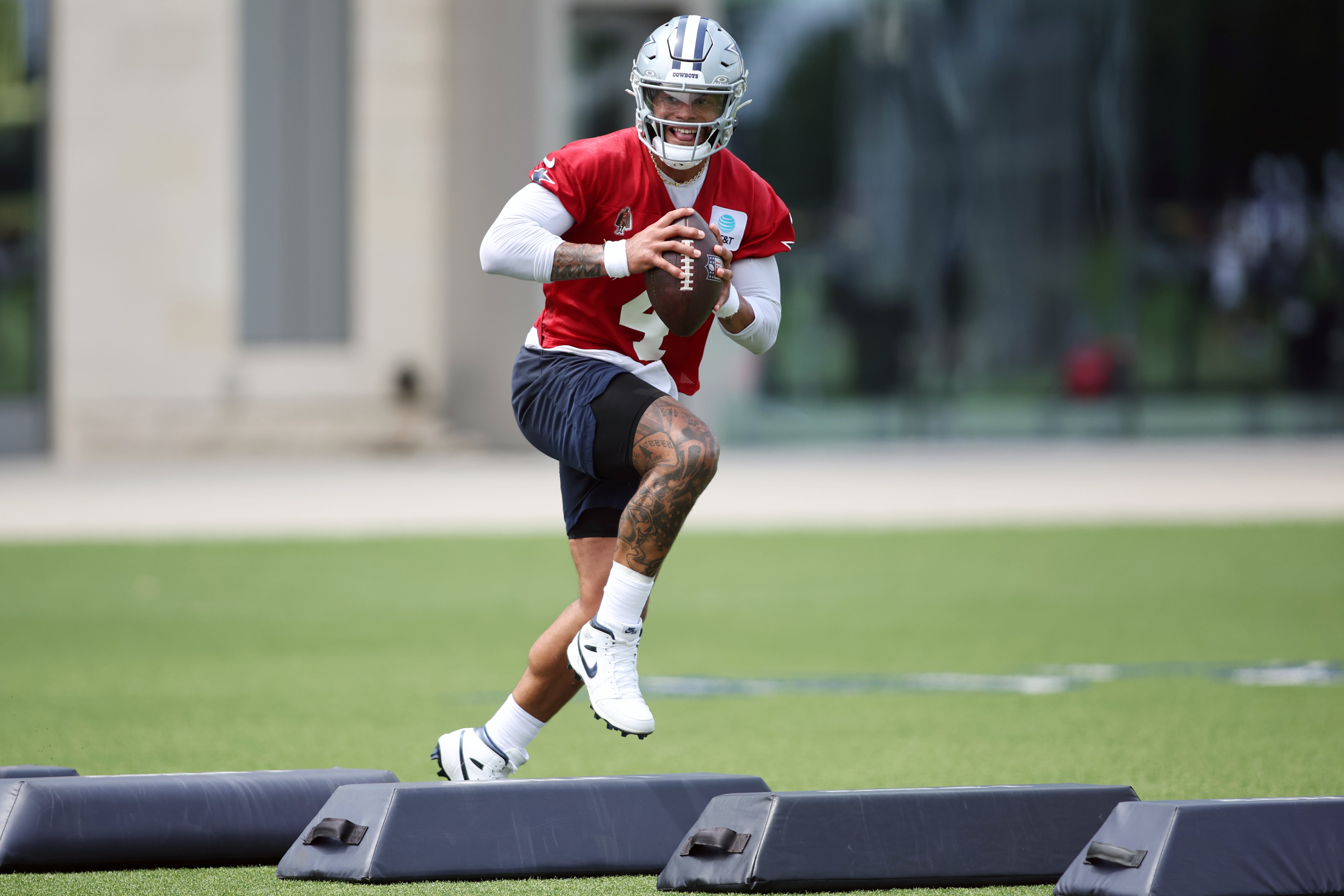 Dallas Cowboys quarterback Dak Prescott (4) goes through a drill during practice at the Ford Center at the Star Training Facility in Frisco, Texas.