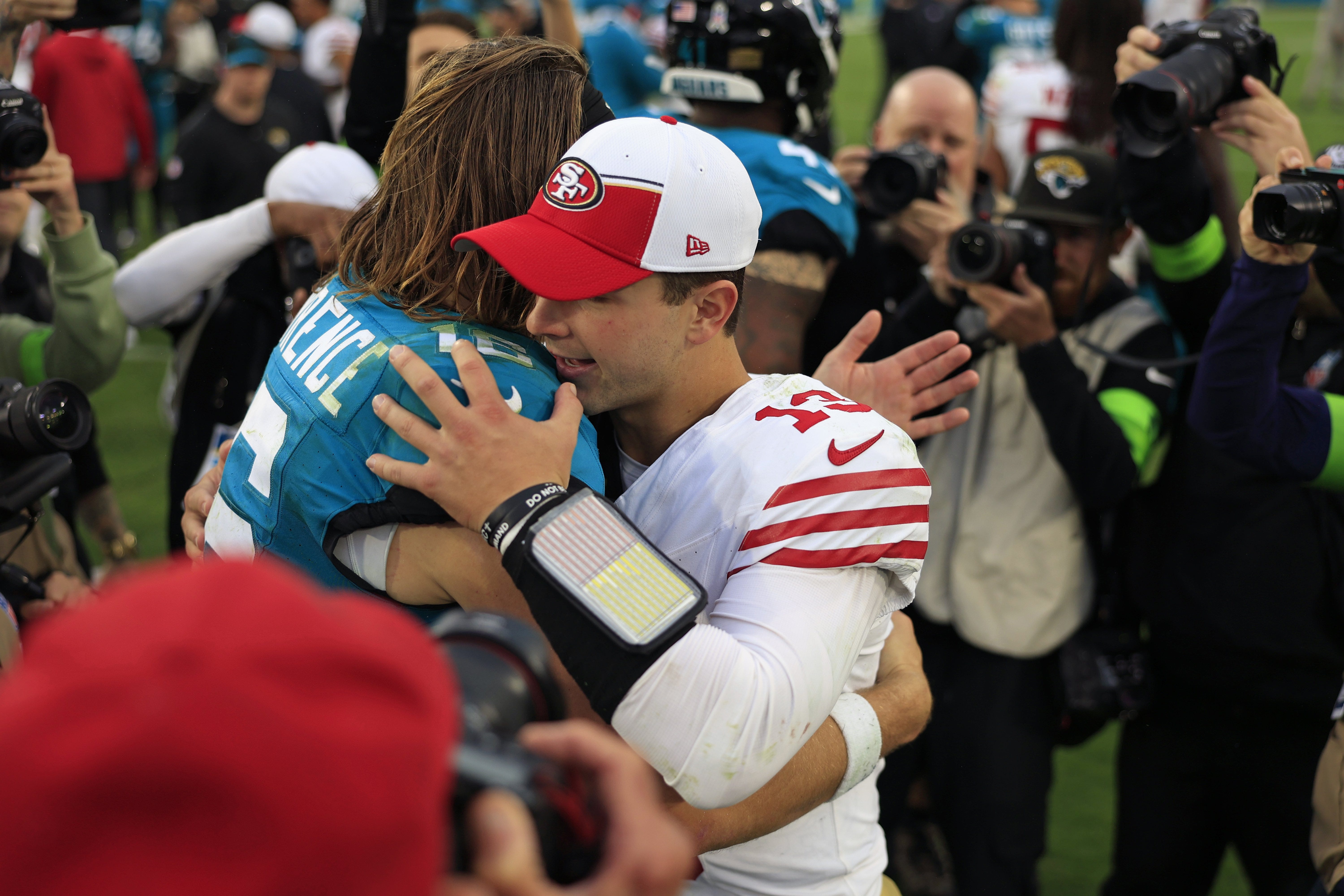 Jacksonville Jaguars quarterback Trevor Lawrence (16) hugs San Francisco 49ers quarterback Brock Purdy (13) after the game of an NFL football game Sunday, Nov. 12, 2023 at EverBank Stadium in Jacksonville, Fla. The San Francisco 49ers defeated the Jacksonville Jaguars 34-3. 