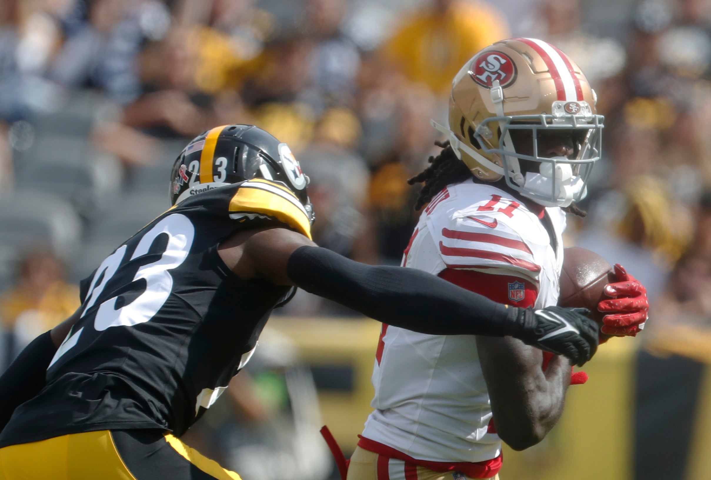 Sep 10, 2023; Pittsburgh, Pennsylvania, USA; San Francisco 49ers wide receiver Brandon Aiyuk (11) runs after a catch against Pittsburgh Steelers safety Damontae Kazee (23) during the third quarter at Acrisure Stadium. San Francisco won 30-7.Mandatory Credit: Charles LeClaire-USA TODAY Sports  