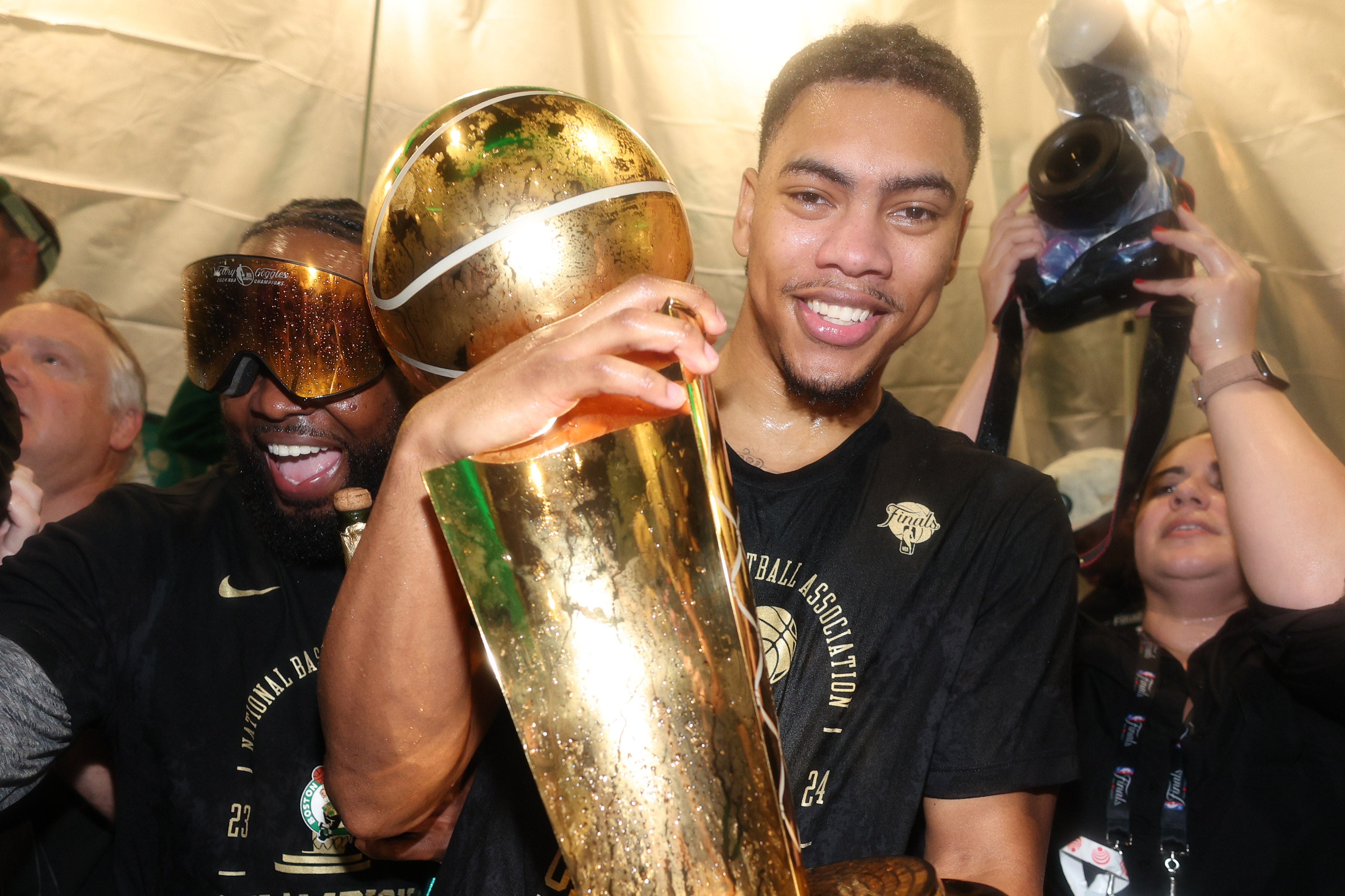 Jun 17, 2024; Boston, Massachusetts, USA; Boston Celtics guard Jaden Springer (44) celebrates in the locker room after winning the 2024 NBA Finals against the Dallas Mavericks at TD Garden.