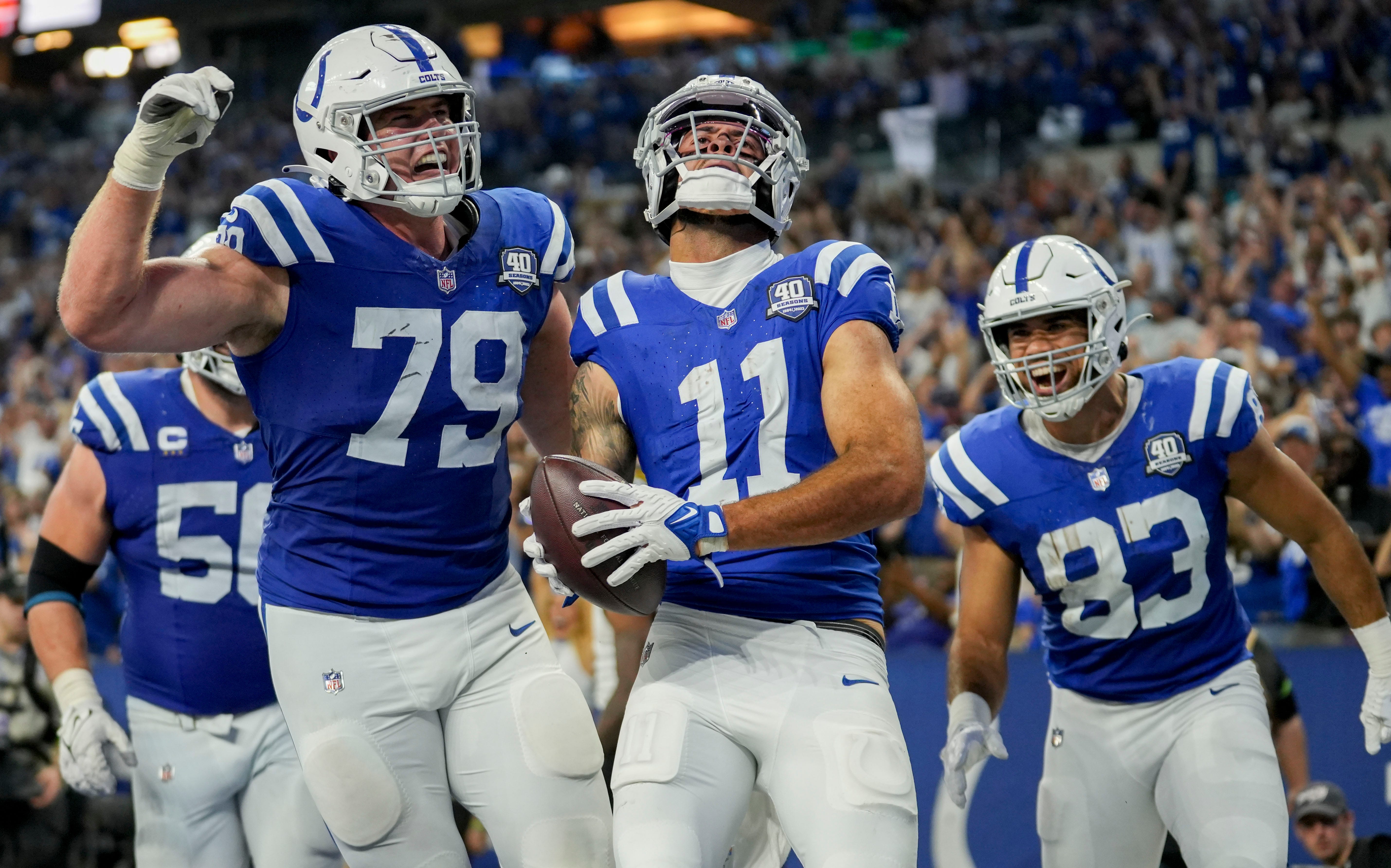 Indianapolis Colts offensive tackle Bernhard Raimann (79) and Indianapolis Colts tight end Kylen Granson (83) celebrate with Indianapolis Colts wide receiver Michael Pittman Jr. (11) after a touchdown Sunday, Sept. 10, 2023, during a game against the Jacksonville Jaguars at Lucas Oil Stadium in Indianapolis.