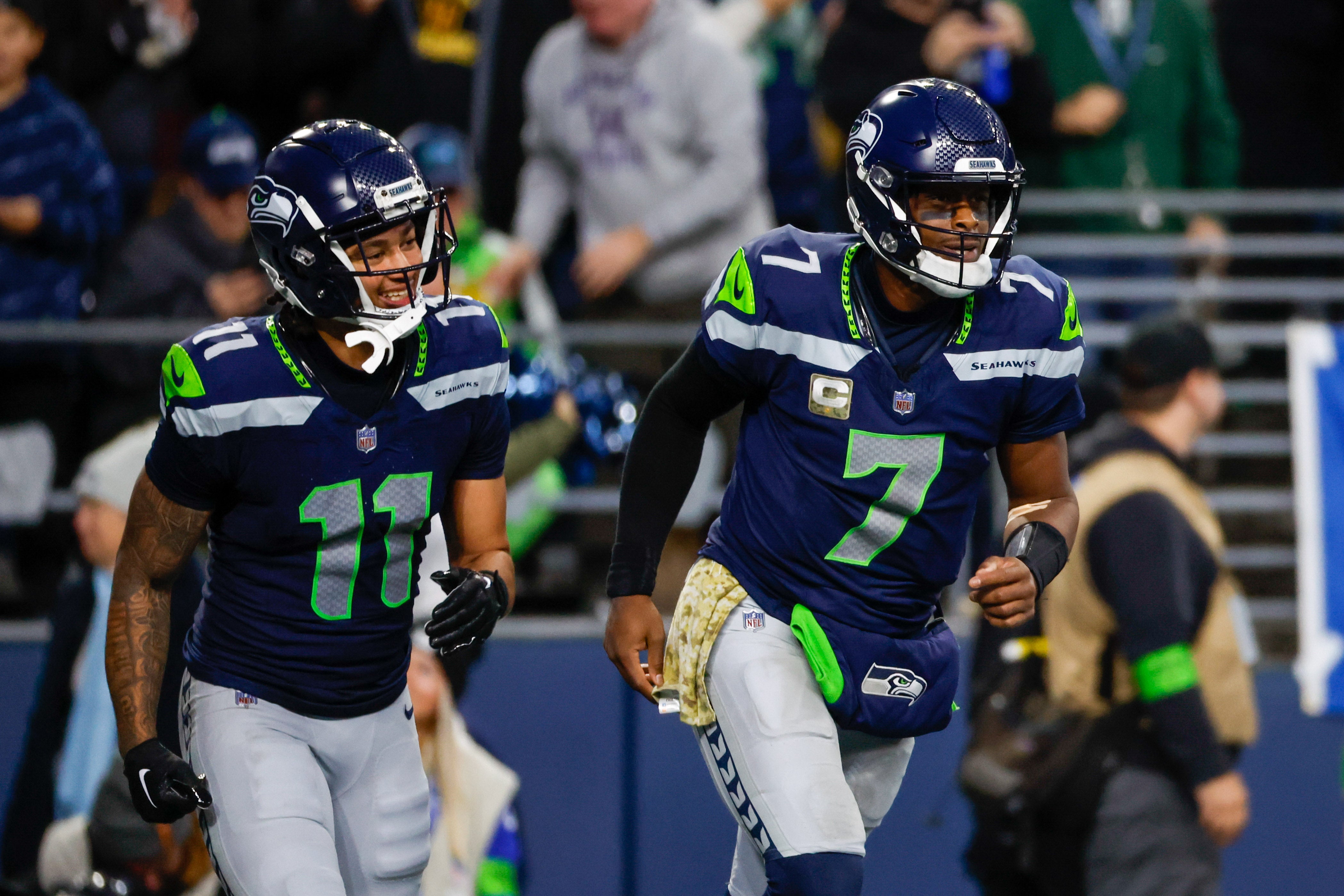 Nov 12, 2023; Seattle, Washington, USA; Seattle Seahawks quarterback Geno Smith (7) celebrates with wide receiver Jaxon Smith-Njigba (11) after throwing a touchdown pass against the Washington Commanders during the fourth quarter at Lumen Field.