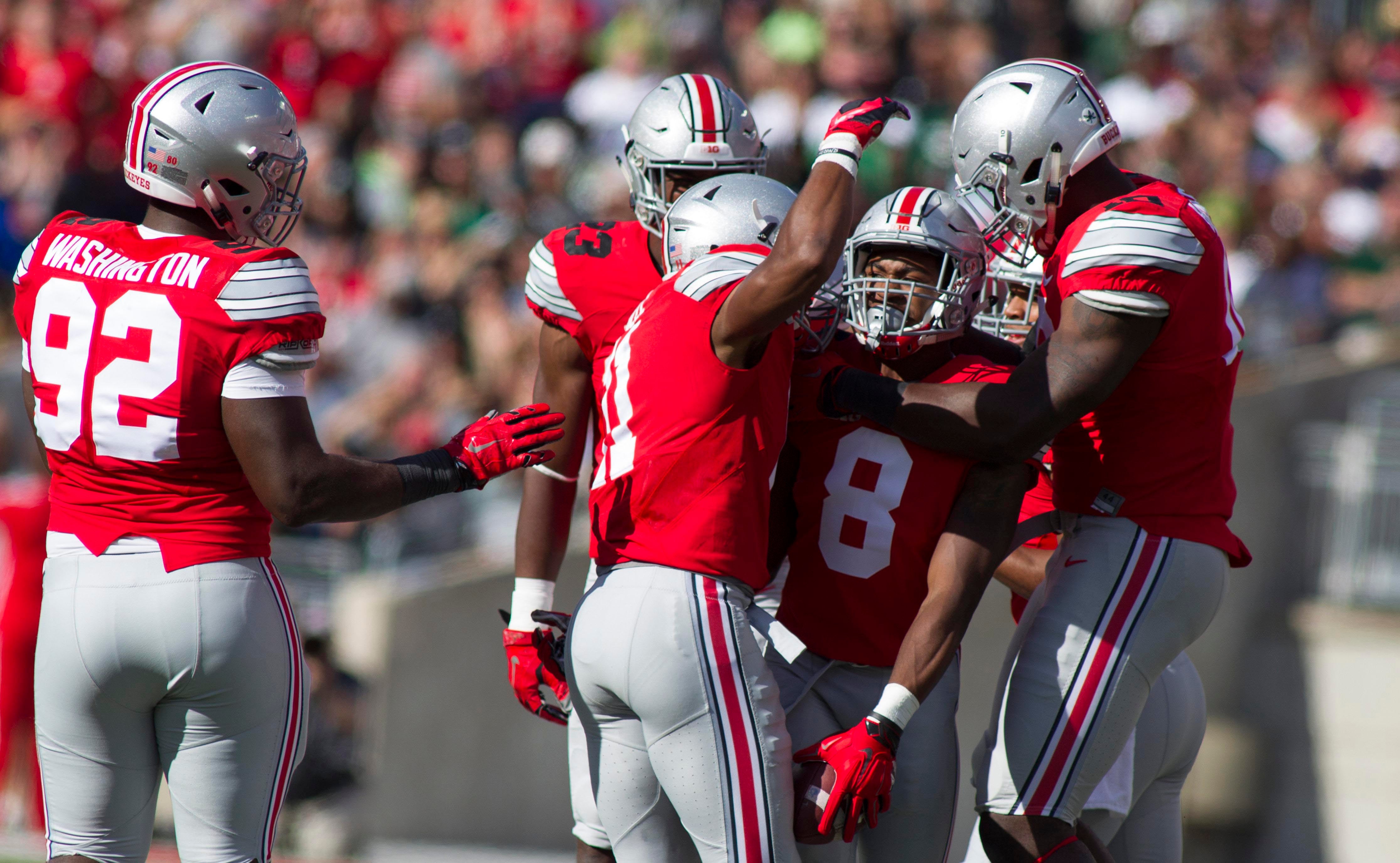 Ohio State Buckeyes cornerback Gareon Conley (8) celebrates his interception with teammates in the second quarter of the game against the Hawaii Warriors at Ohio Stadium.