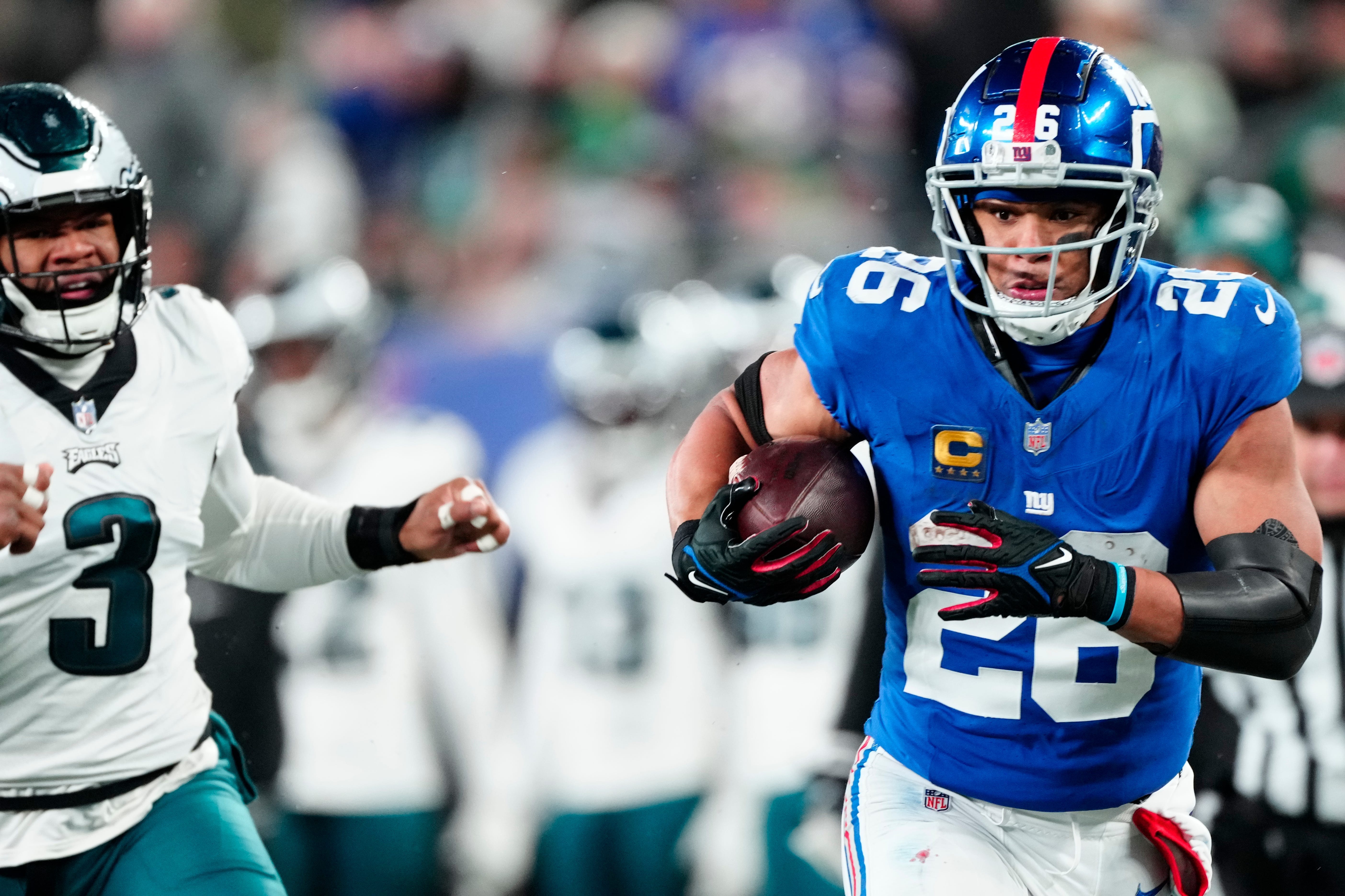 New York Giants running back Saquon Barkley (26) heads to the goal line in the second quarter past Philadelphia Eagles linebacker Nolan Smith (3) on Sunday, Jan. 7, 2024.