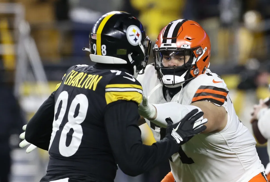 Cleveland Browns offensive tackle Jedrick Wills (71) pass blocks at he line of scrimmage against Pittsburgh Steelers defensive end Taco Charlton (98) during the fourth quarter at Heinz Field.