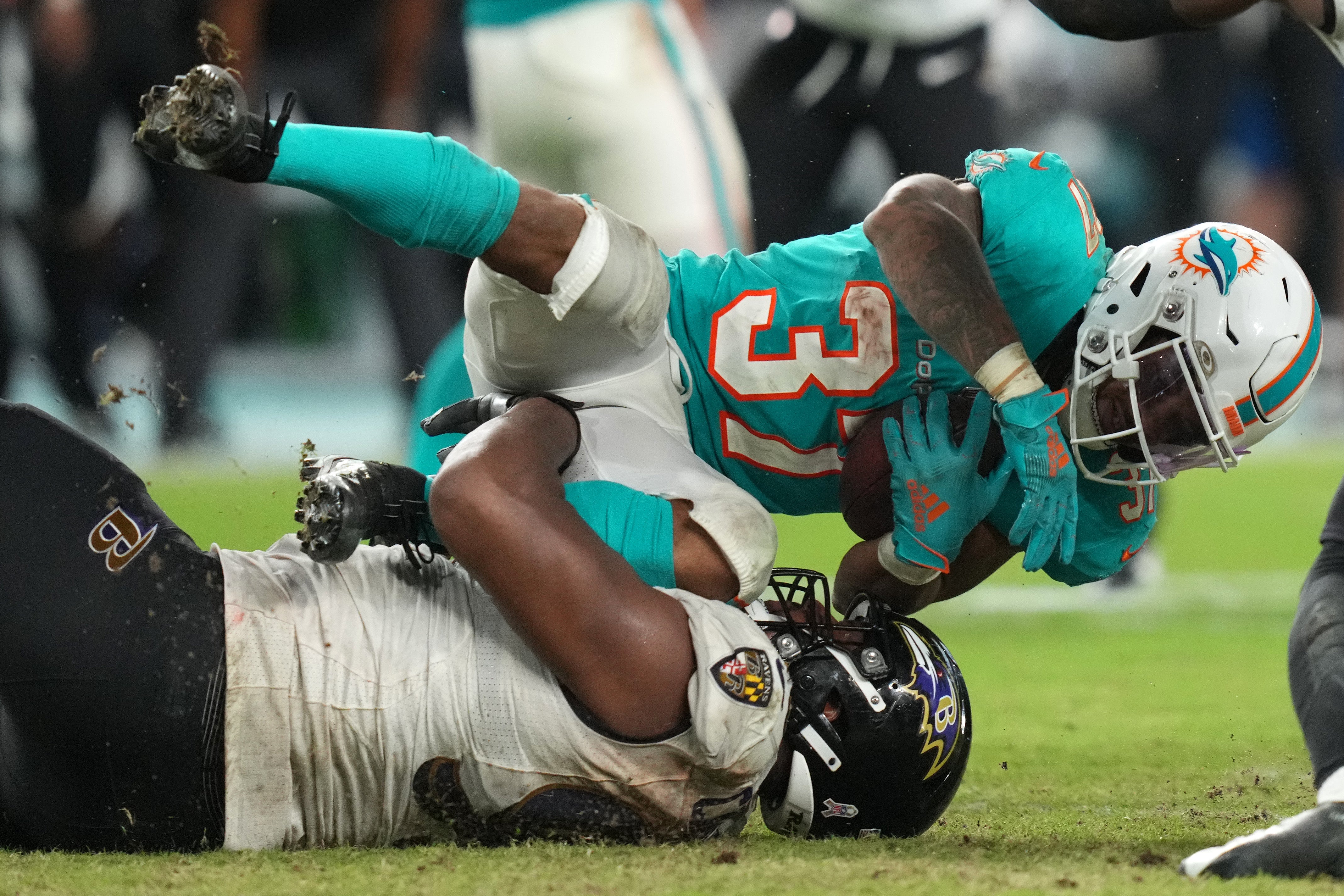 Nov 11, 2021; Miami Gardens, Florida, USA; Baltimore Ravens defensive end Calais Campbell (93) tackles Miami Dolphins running back Myles Gaskin (37) during the second half at Hard Rock Stadium.