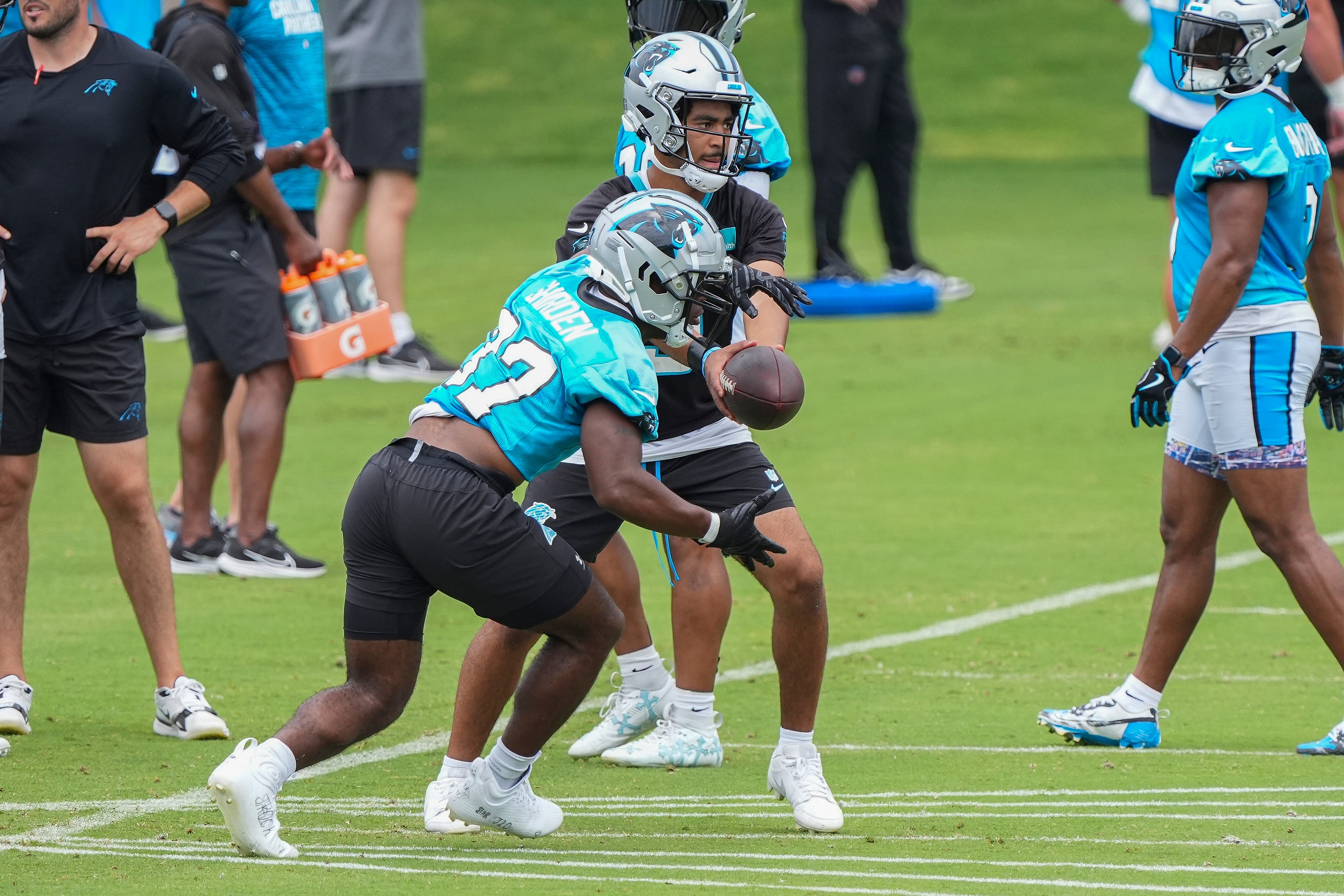 Jun 4, 2024; Charlotte, NC, USA; Carolina Panthers quarterback Bryce Young (9) hands off to running back Jaden Shirden (37) during OTAs. Mandatory Credit: Jim Dedmon-USA TODAY Sports