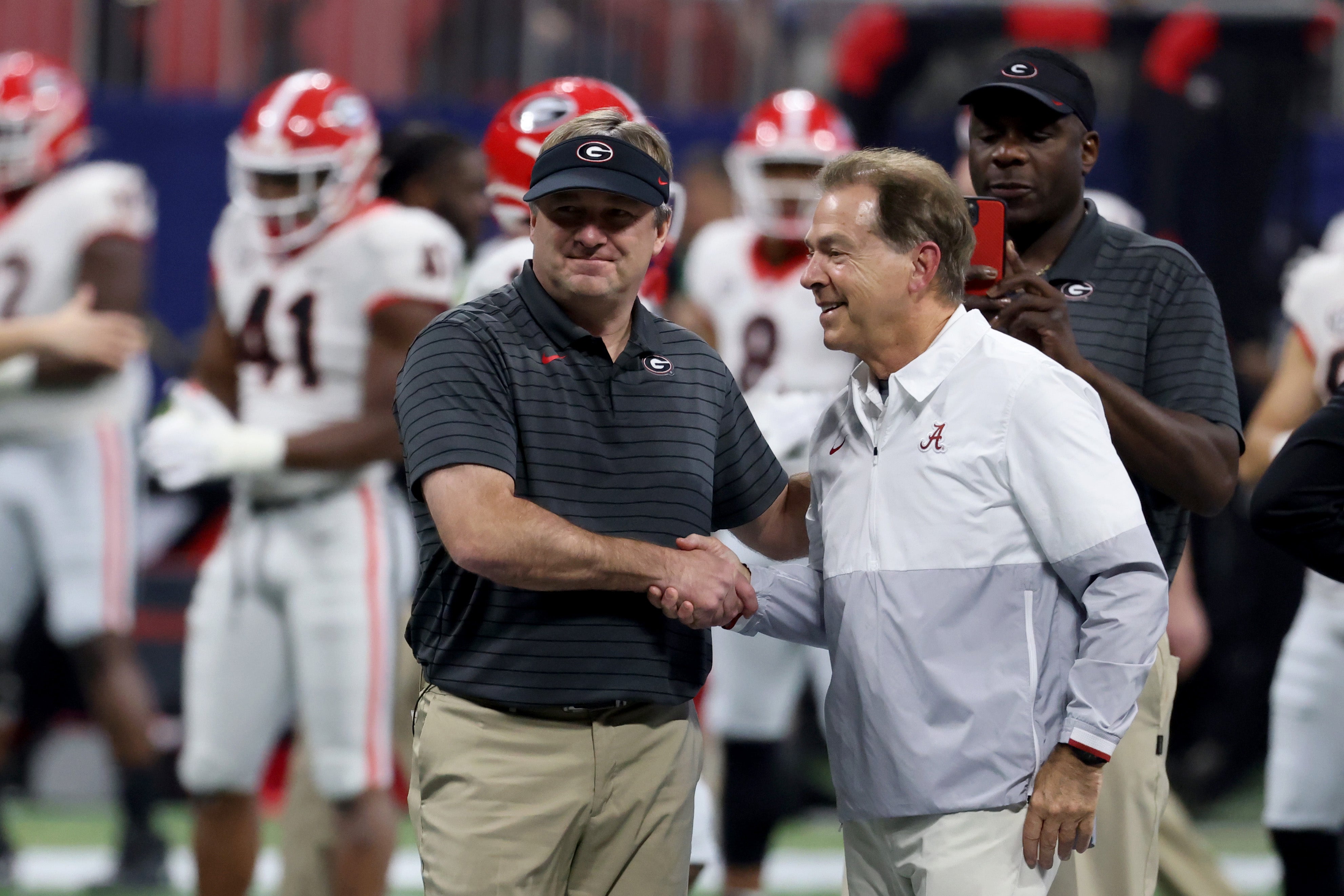 Georgia Bulldogs head coach Kirby Smart greets Alabama Crimson Tide head coach Nick Saban before the SEC championship game at Mercedes-Benz Stadium.