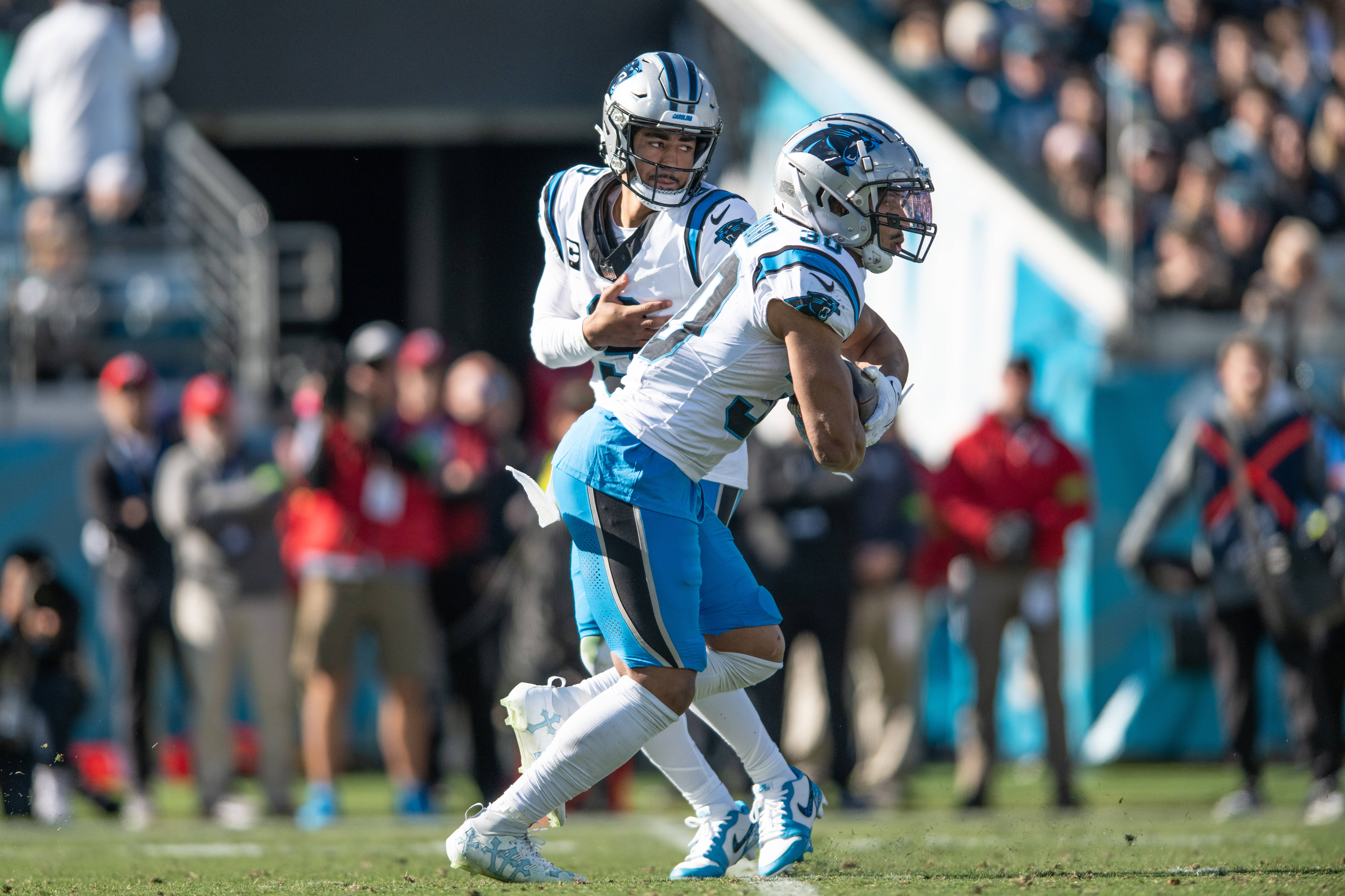 Dec 31, 2023; Jacksonville, Florida, USA; Carolina Panthers quarterback Bryce Young (9) hands the ball off to running back Chuba Hubbard (30) against the Jacksonville Jaguars in the second quarter at EverBank Stadium. Mandatory Credit: Jeremy Reper-USA TODAY Sports