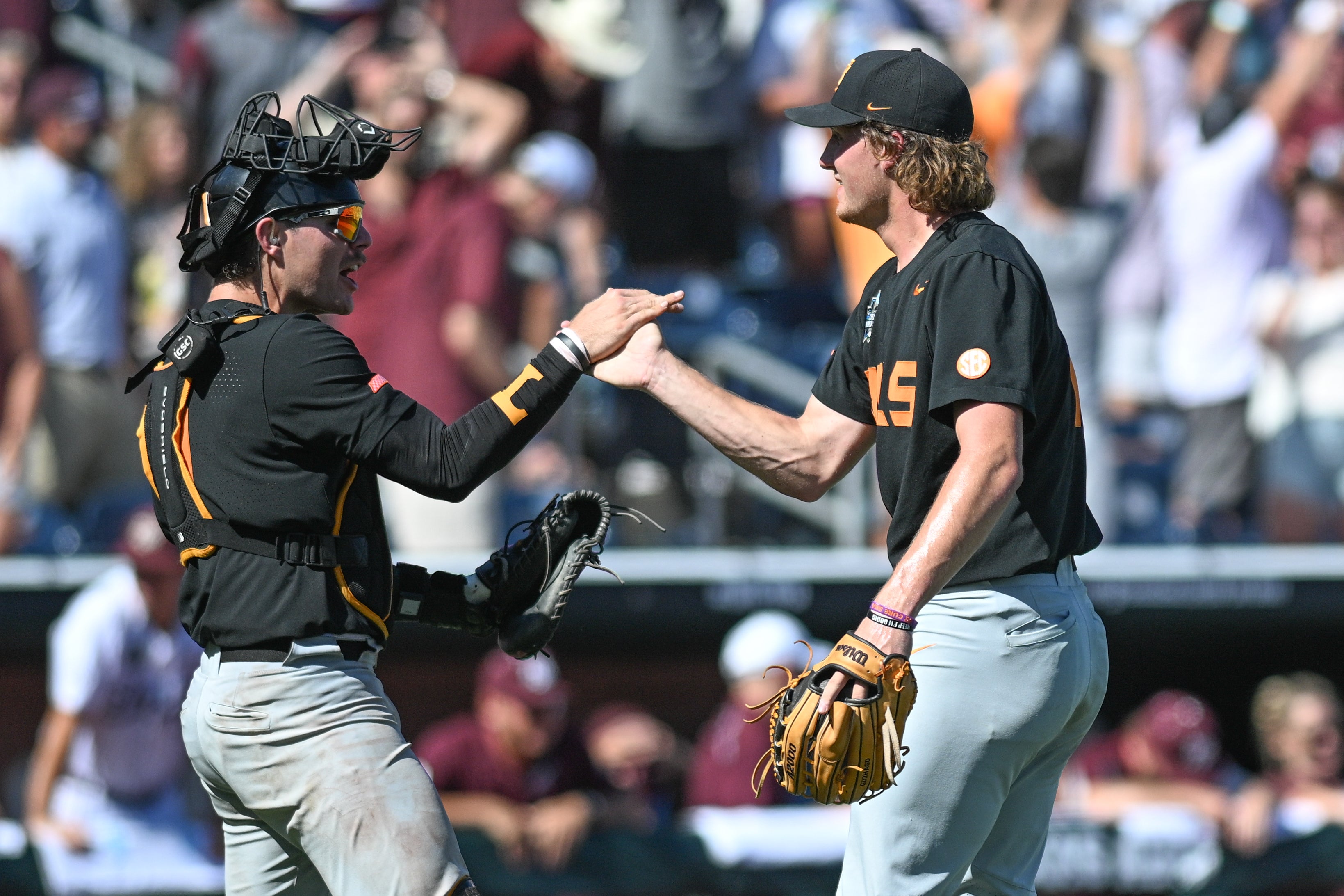Jun 23, 2024; Omaha, NE, USA; Tennessee Volunteers pitcher Nate Snead (7) celebrates the win with catcher Cal Stark (10) over the Texas A&M Aggies at Charles Schwab Field Omaha.
