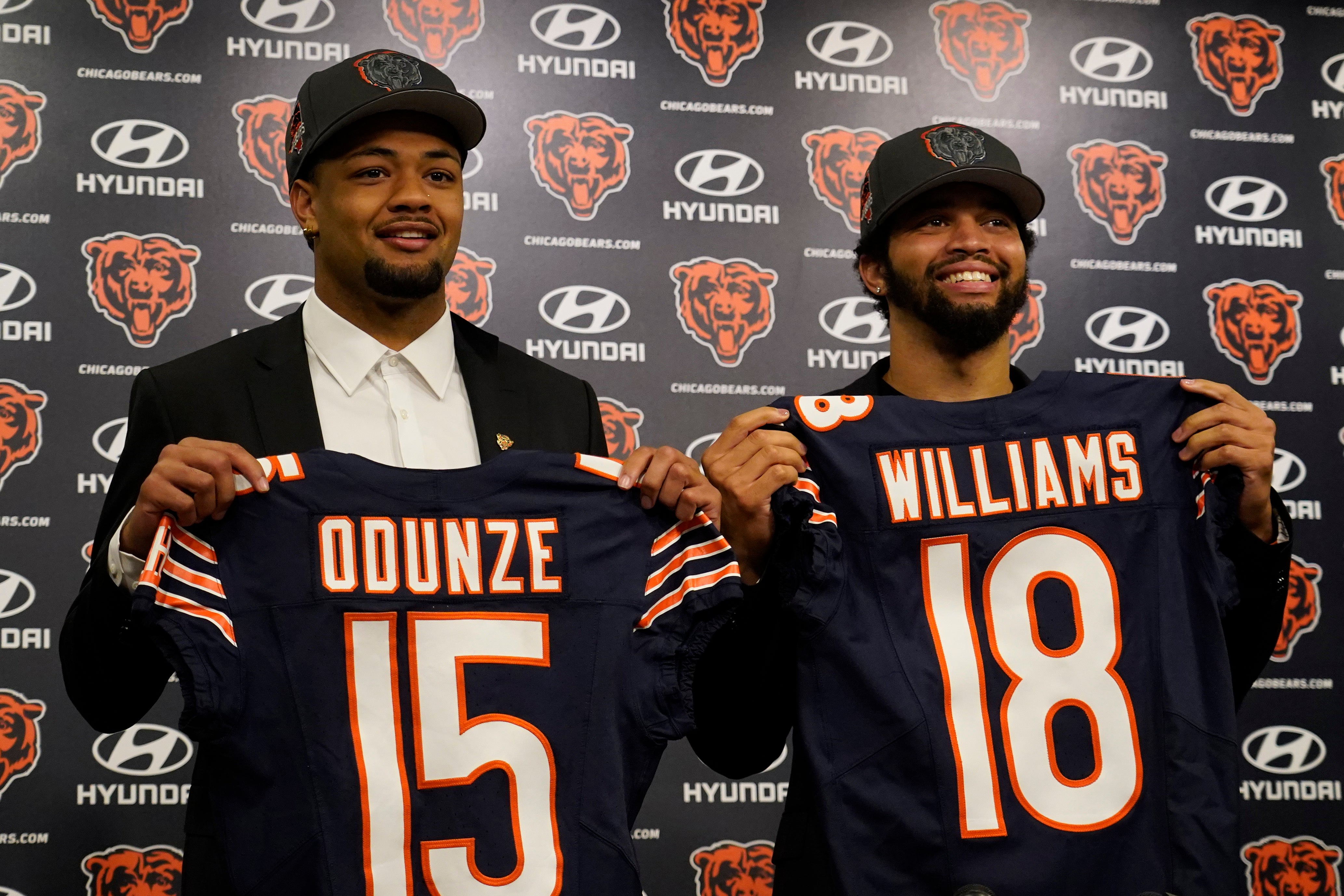 Apr 26, 2024; Lake Forest, IL, USA; Chicago Bears first round draft choices Rome Odunze (left) and Caleb Williams (right) pose for photos at a press conference at Halas Hall.