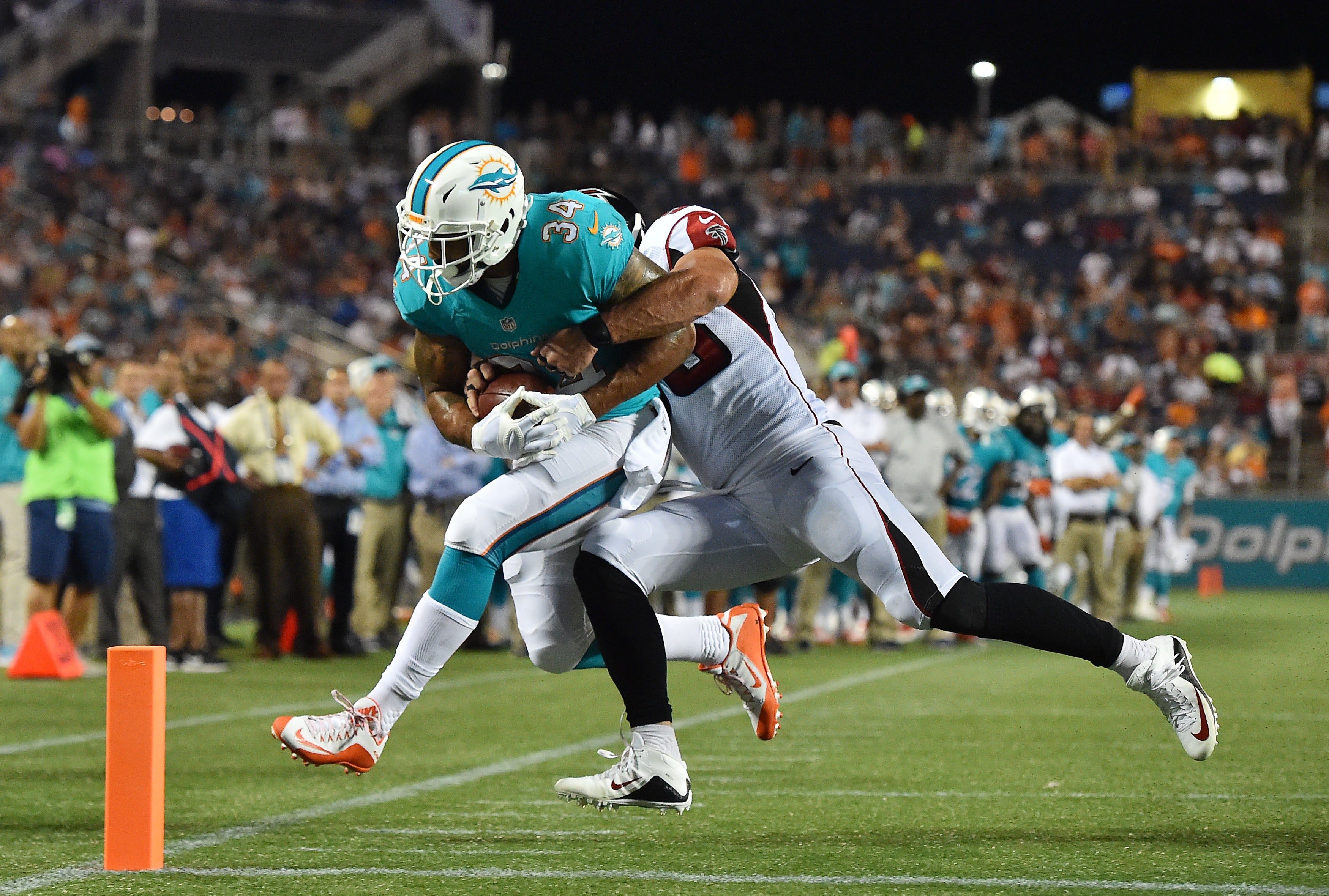 Atlanta Falcons middle linebacker Paul Worrilow (55) tackles Miami Dolphins running back Arian Foster (34) during the first half at Camping World Stadium.