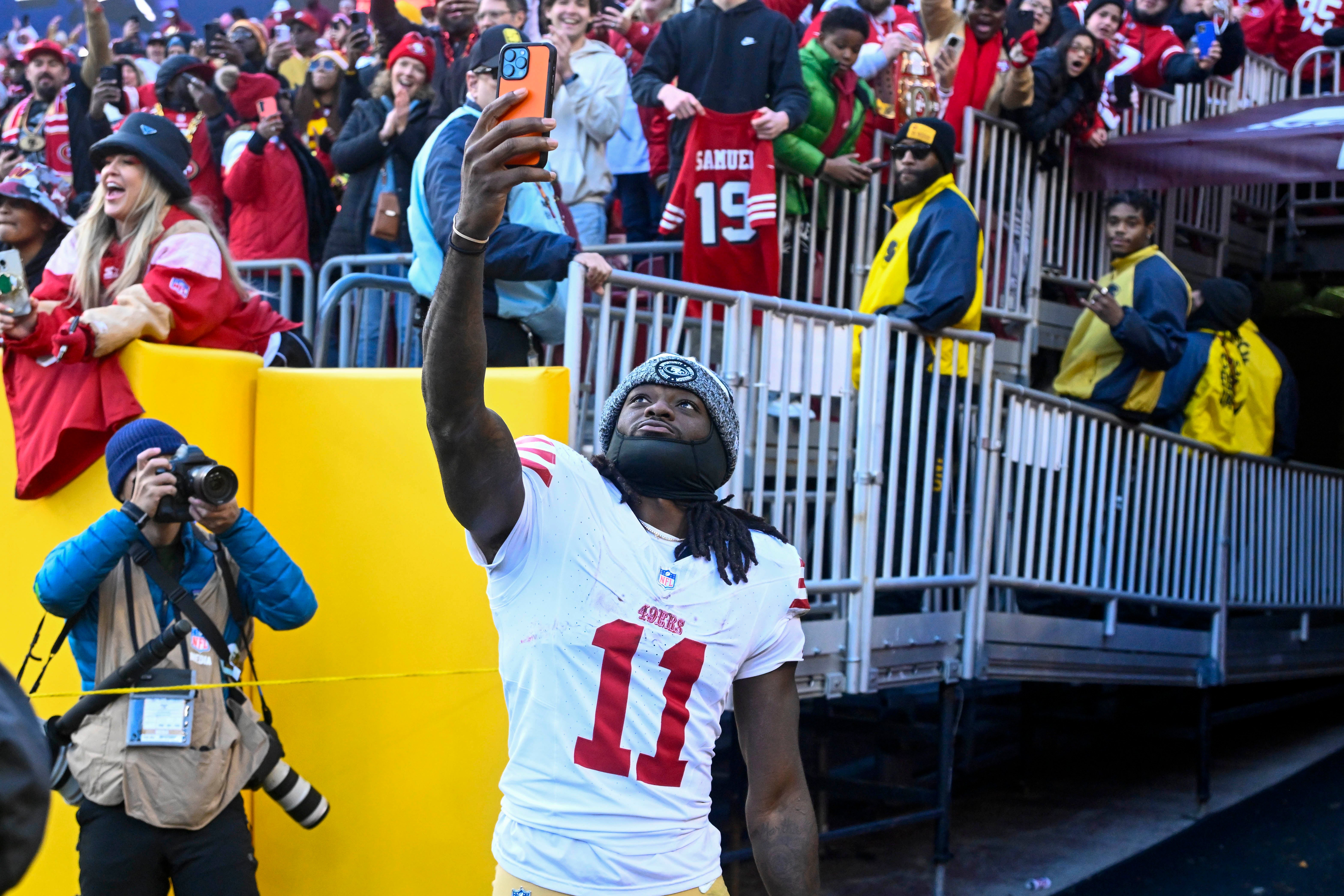 Dec 31, 2023; Landover, Maryland, USA; San Francisco 49ers wide receiver Brandon Aiyuk (11) celebrates with fans after defeating the Washington Commanders at FedExField.