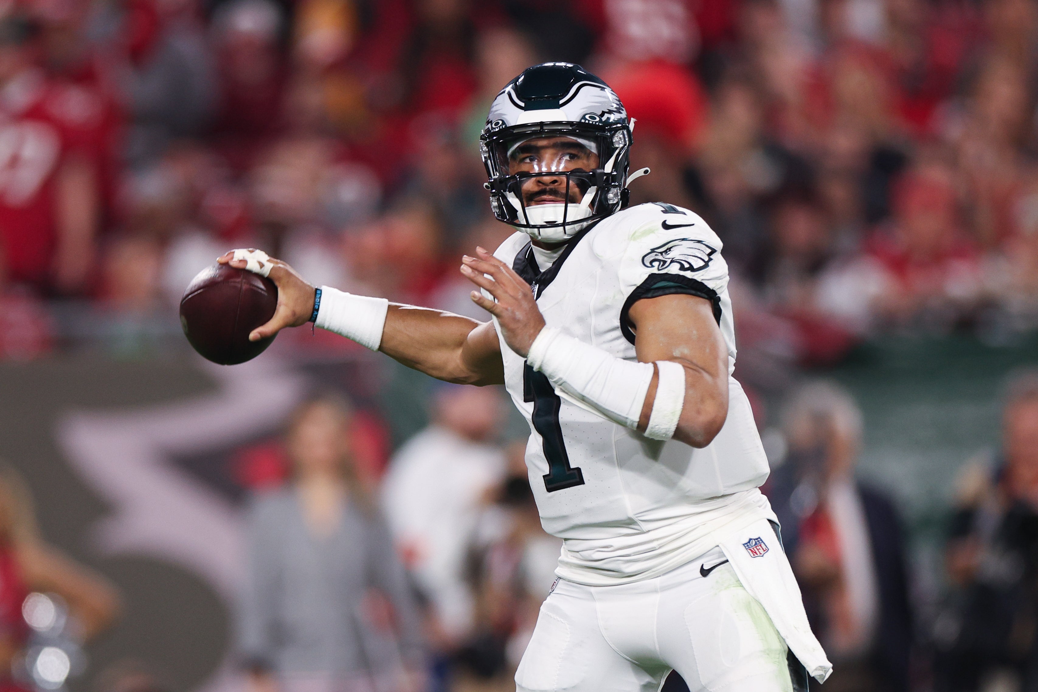 Philadelphia Eagles quarterback Jalen Hurts (1) looks for a pass against the Tampa Bay Buccaneers during the first half a 2024 NFC wild card game at Raymond James Stadium.