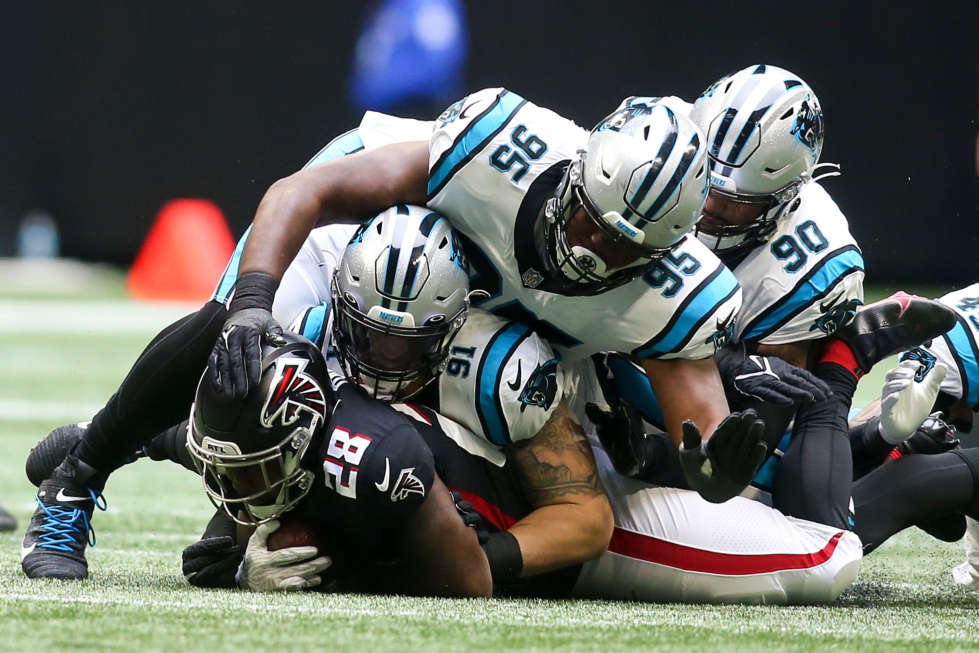 Oct 31, 2021; Atlanta, Georgia, USA; Atlanta Falcons running back Mike Davis (28) is tackled by Carolina Panthers defensive end Morgan Fox (91) and defensive tackle Derrick Brown (95) and defensive end DaQuan Jones (90) in the first quarter at Mercedes-Benz Stadium. Mandatory Credit: Brett Davis-USA TODAY Sports