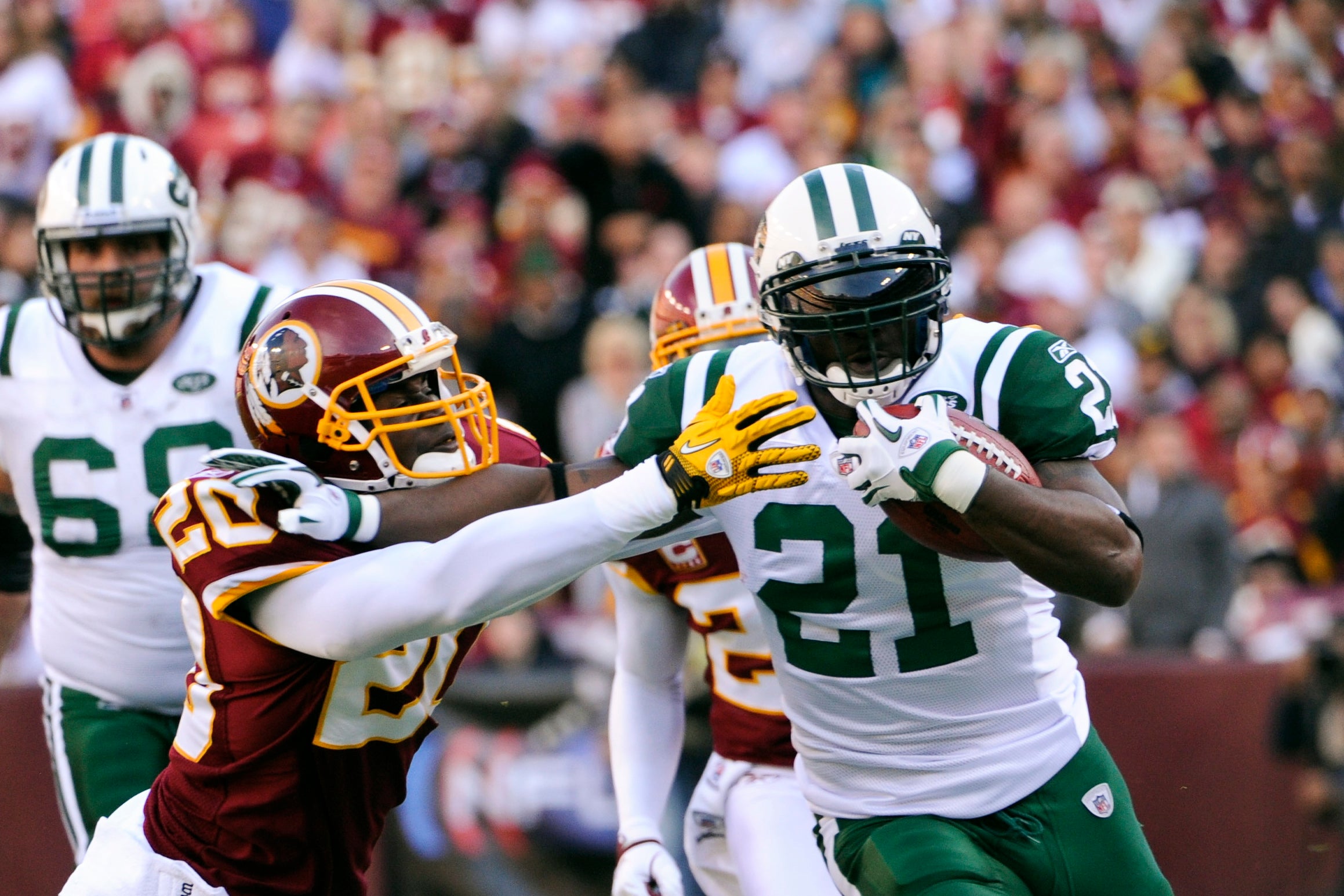 Washington Redskins safety Oshiomogho Atogwe (20) tackles New York Jets running back LaDainian Tomlinson (21) during the first quarter at FedEx Field.
